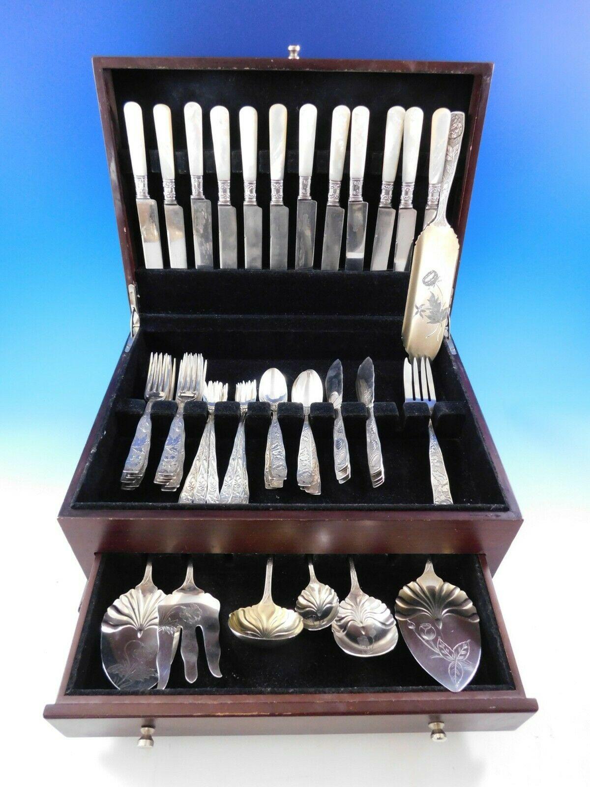 Scarce Orchids by Towle multi-motif sterling silver flatware set, 68 pieces (including Mother of Pearl knives). First introduced in 1887, this multi-motif pattern displays a finely detailed varying floral motif on a unique textured swirl background.