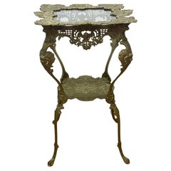 Ornate 1920's Two-Tier Brass Table w/Glass Top decorated with cherubs 