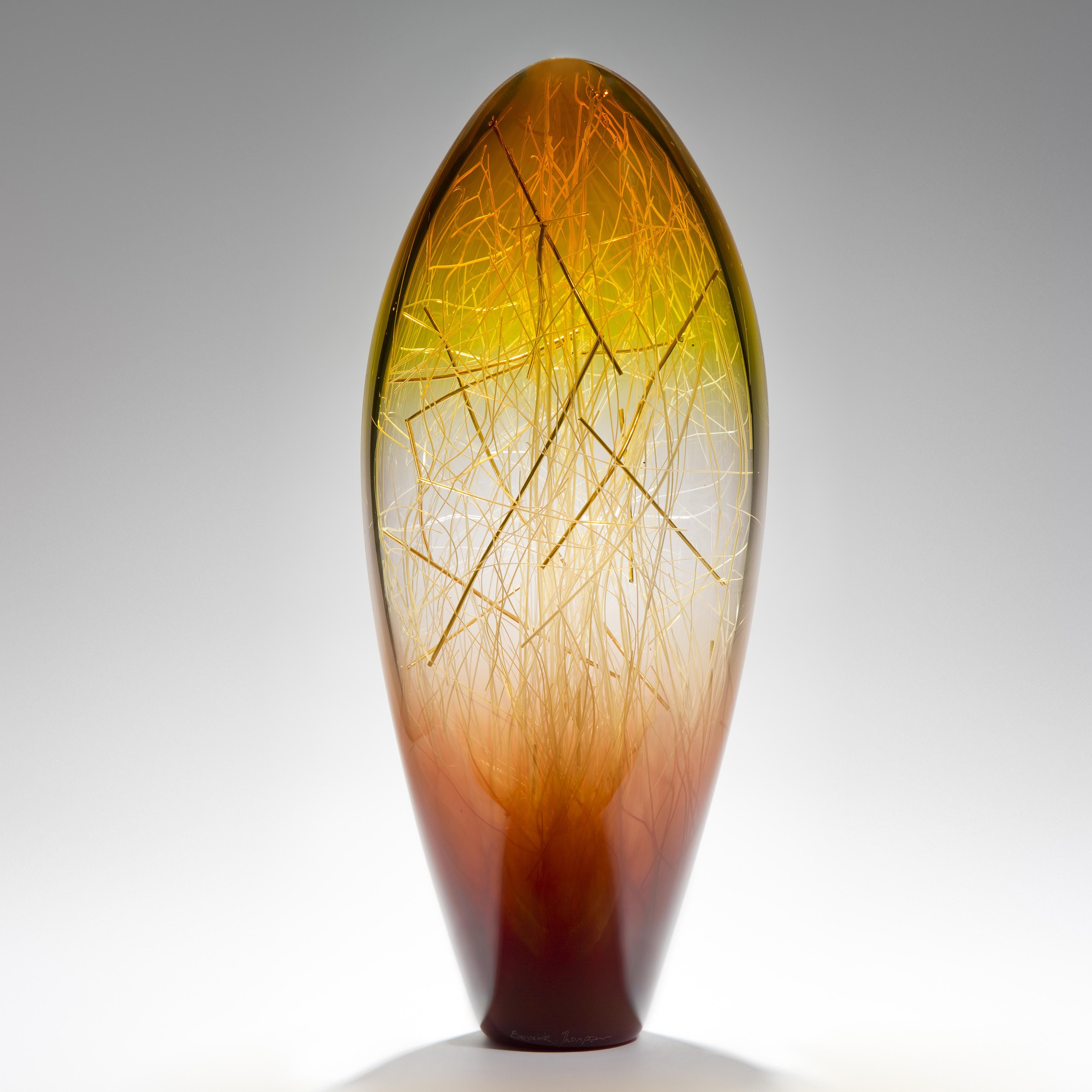 Ore in Amber and Coffee is a unique glass sculpture in amber, coffee and clear coloured glass by the collaborative artists Hanne Enemark (Danish) and Louis Thompson (British). The outer glass form contains a multitude of Fine white canes of glass,
