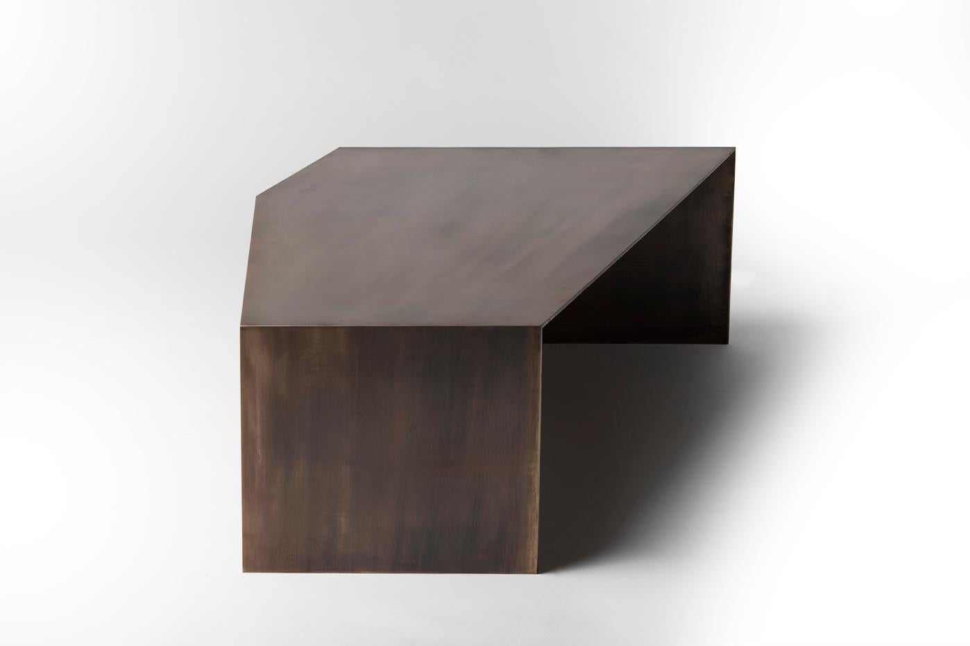 The ore coffee table by Taylor Donsker features a set of nesting tables, an organic table in California walnut and bronze, and a geometric table in bronze. 
 The two tables may be separated entirely or partially to suit a variety of living space