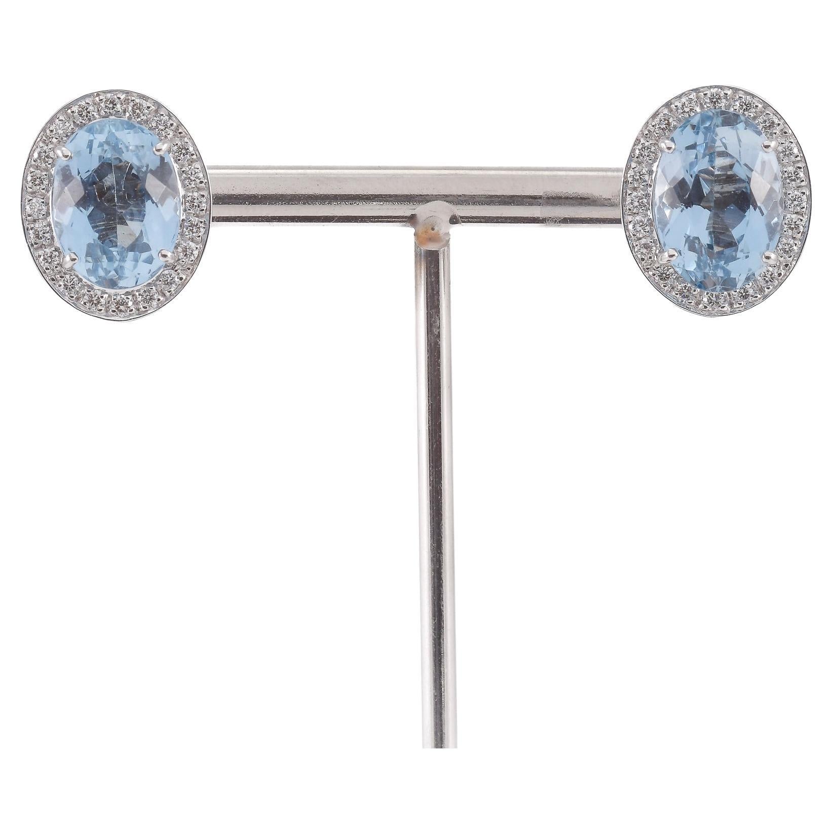 Boucles d
oreilles en or blanc avec diamants et topazes