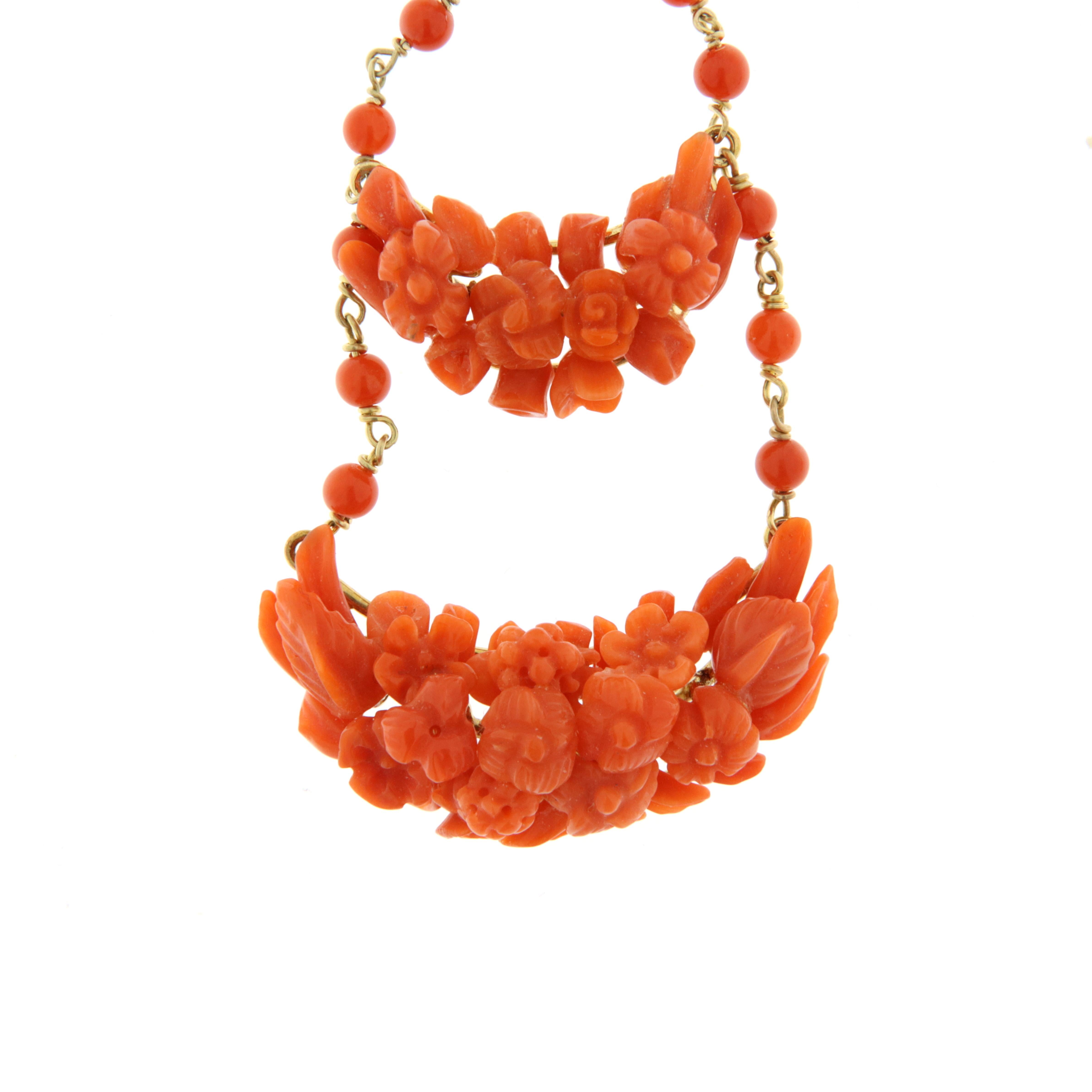 Italian-made earrings, Sicilian in particular, made with many small hand-engraved coral elements in the shapes of little flowers and leaves. The corals are from Sciacca, in the Mediterranean Sea. The chandelier pattern gives these earrings a unique