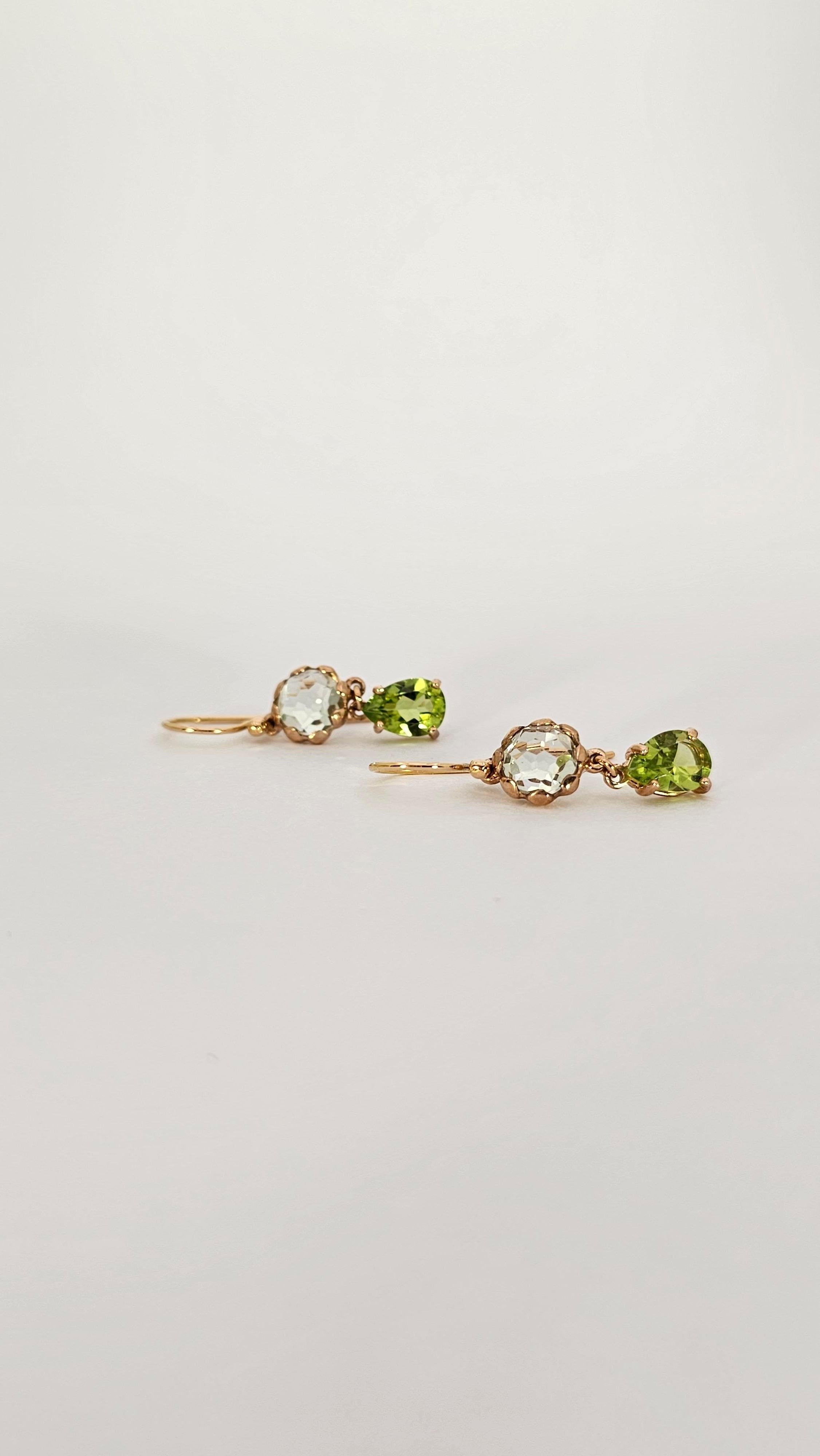 A pair of dangling earrings made of 9 Kt gold and 18 Kt Gold in the upper hook part.
The central part of the earring is composed of Prasiolite  ( variety of Amethyst ) faceted round cut and from Peridot faceted drop cut.
The top stone is set with a
