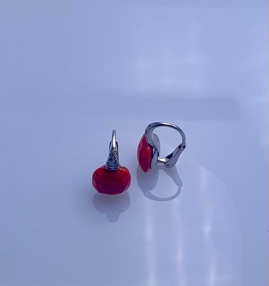 Earring produced by Pomellato in the early 21st century is part of the Capri collection. The item is made of Kt 18 white gold with natural brilliant-cut Diamonds for Ct 0.20 and faceted and stabilized Coral. The production of the coral items in this