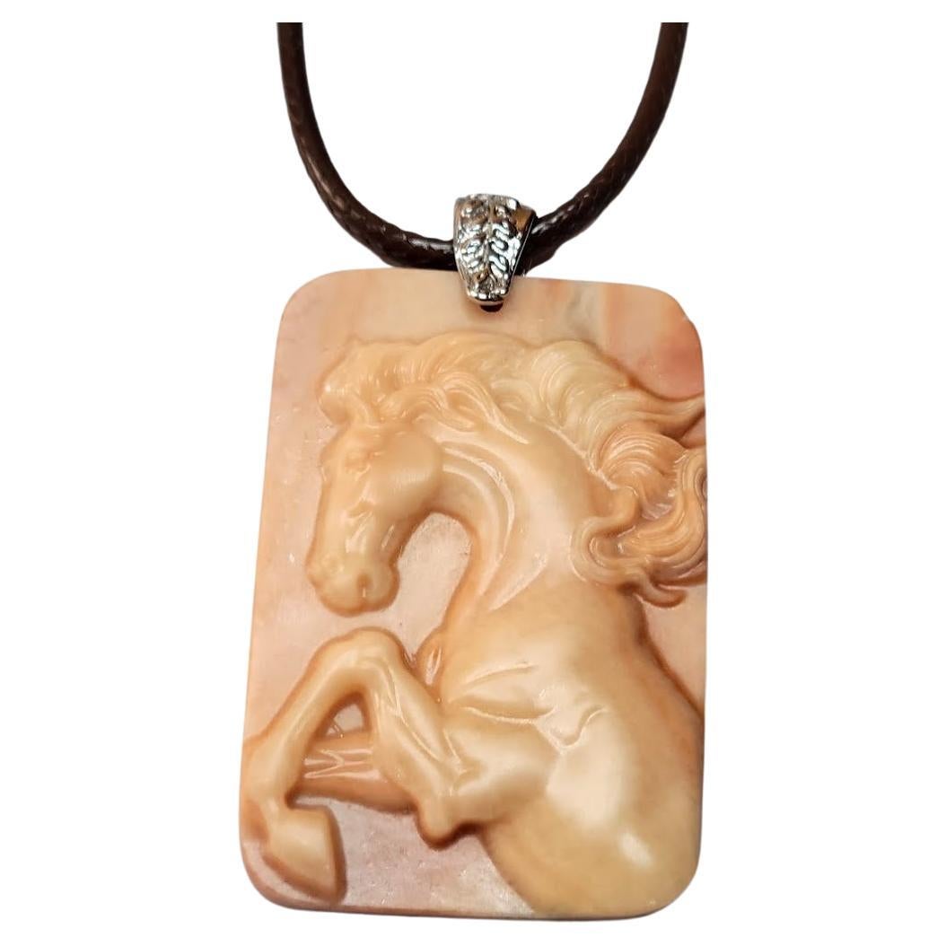 The pendant is a detailed rectangular cameo made of red malachite, 60mm x 40mm. It's a beautiful and rare item!

Red 
