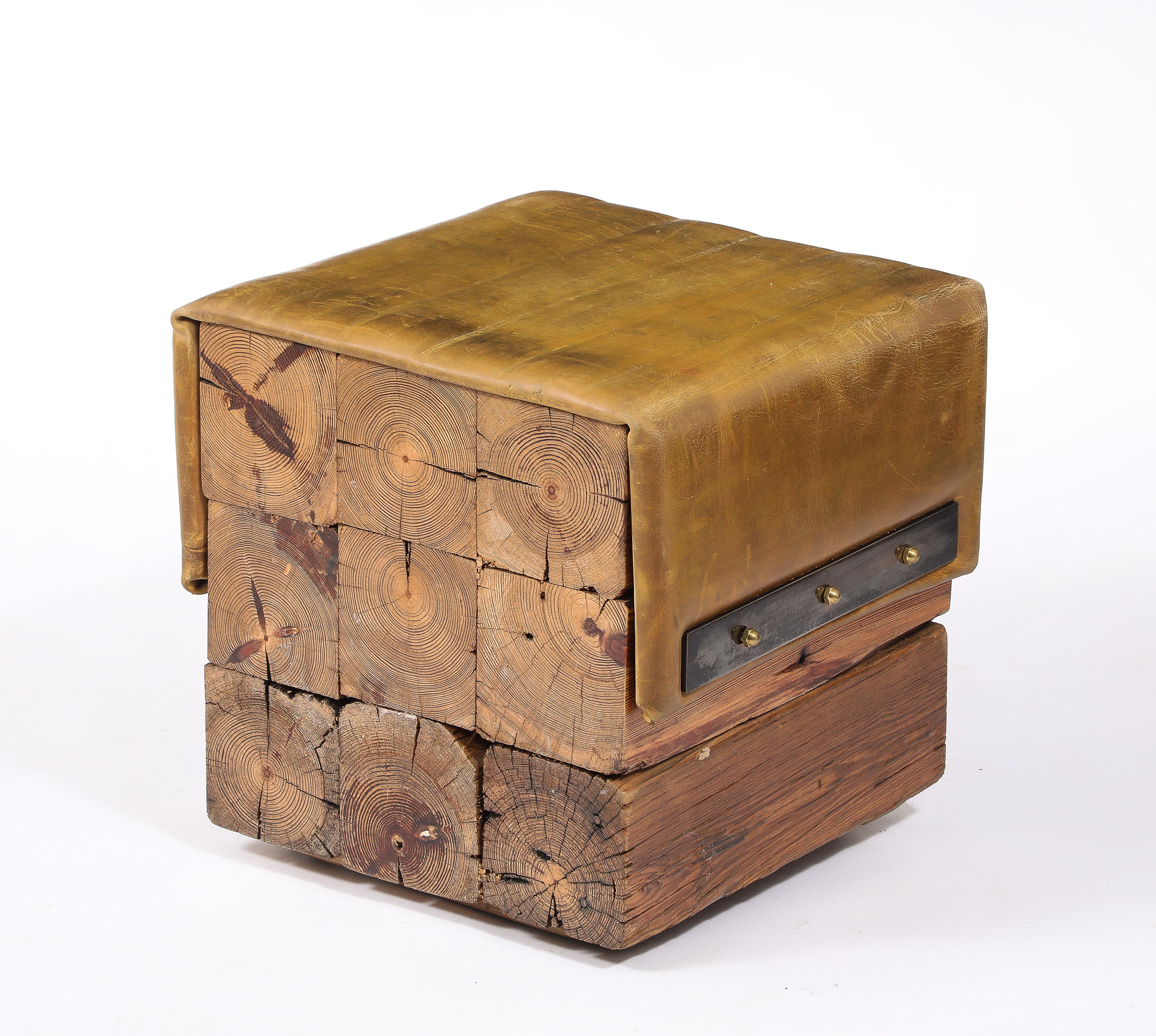 Solid Oregon Pine cubic stools made of large section beams doweled together, covered by a leather seat held in place by brass hardware