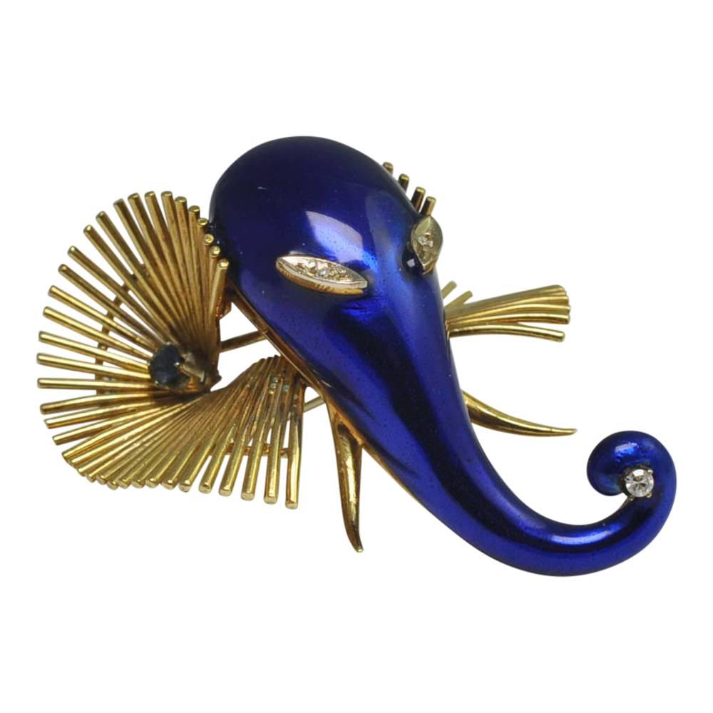 Rare vintage blue enamel and 18ct gold elephant brooch by Italian jewellery designer Oreste Giovanni Corletto.   Our elephant has a royal blue enamel head and curved trunk where she is holding a diamond.  She has large gold ribbed ears with a