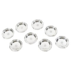ORFEVRE HENIN - Suite of eight solid silver bottle coasters from the 20th