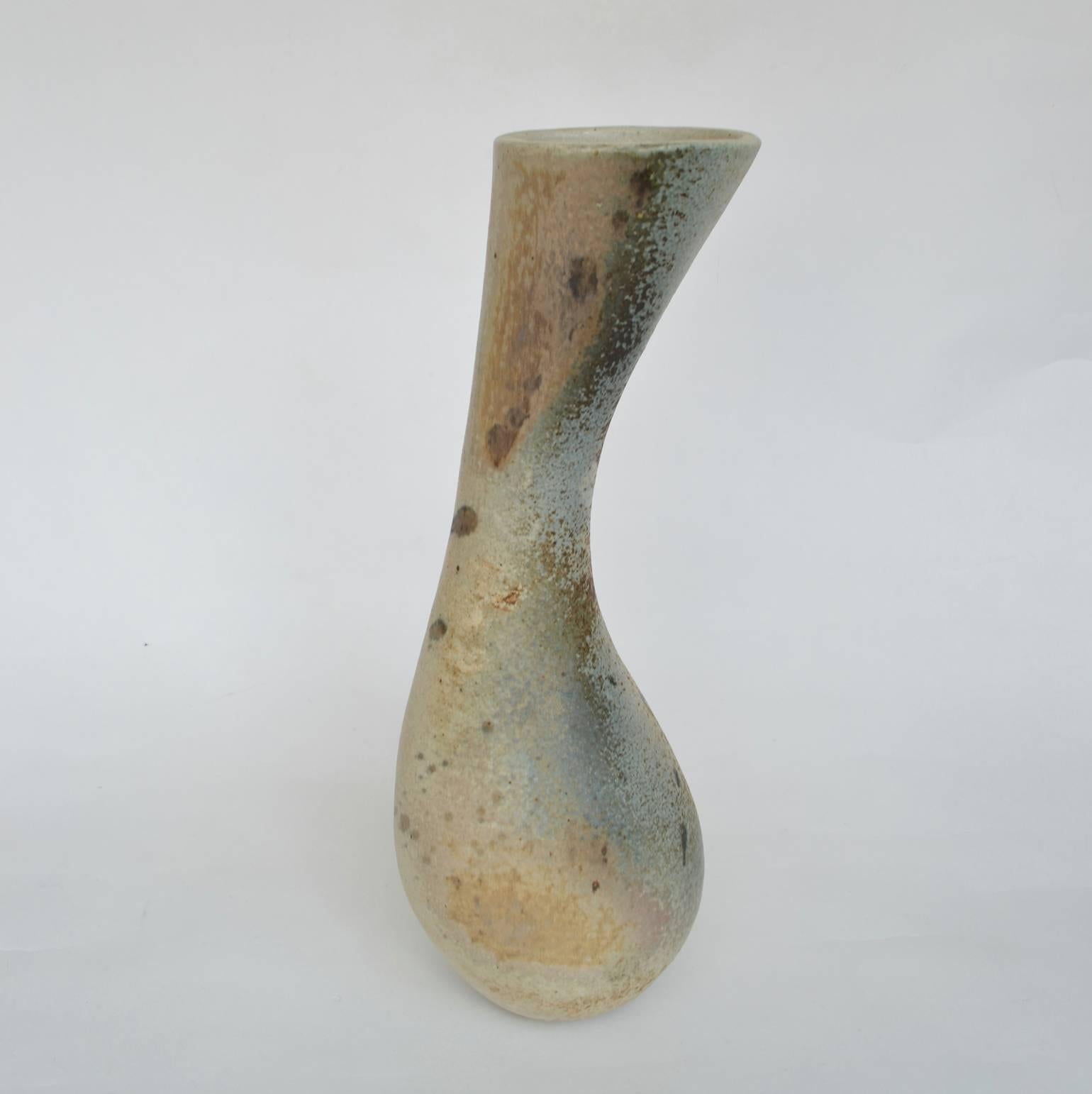 Sculptural Mid Century Modern curvaceous and organic hand formed vase glazed in muted tones of pastel.