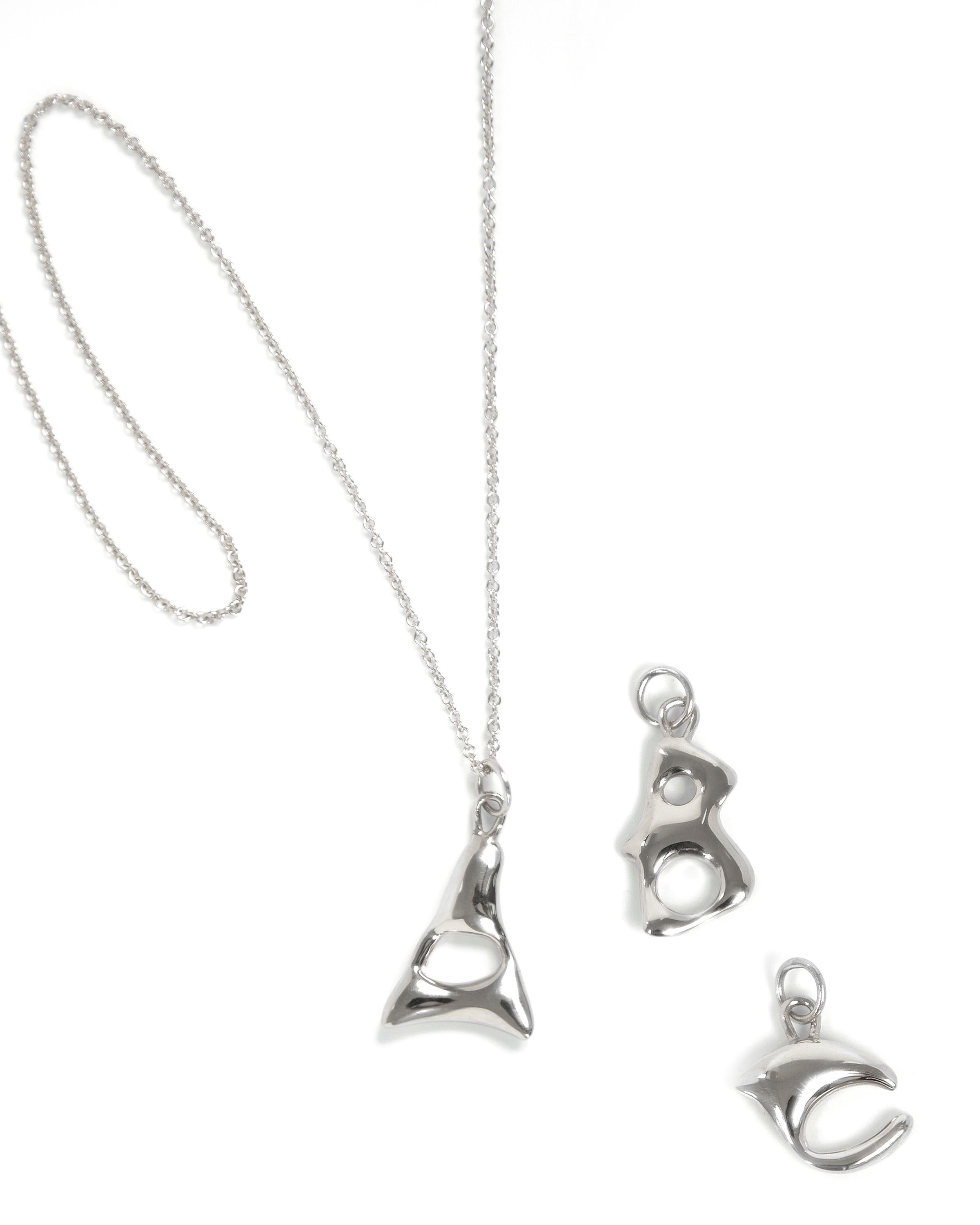 BAR Jewellery, London UK, ALPHABET NECKLACE, Sterling Silver 

Our Alphabet necklaces were designed by hand 'writing' each individual letter using molten wax that is then cast in solid silver. Inspiration for the fluid, tactile letter shapes comes