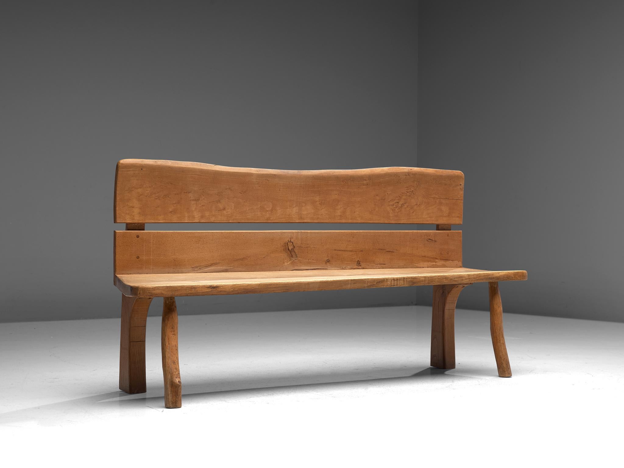 Bench, oak, France, 1960s.

French oak wooden bench that has robust design with organic elements. The bulky bench is made of beautiful oak wood that developed a nice, rustic patina from age and use. The design features solely thick planks with