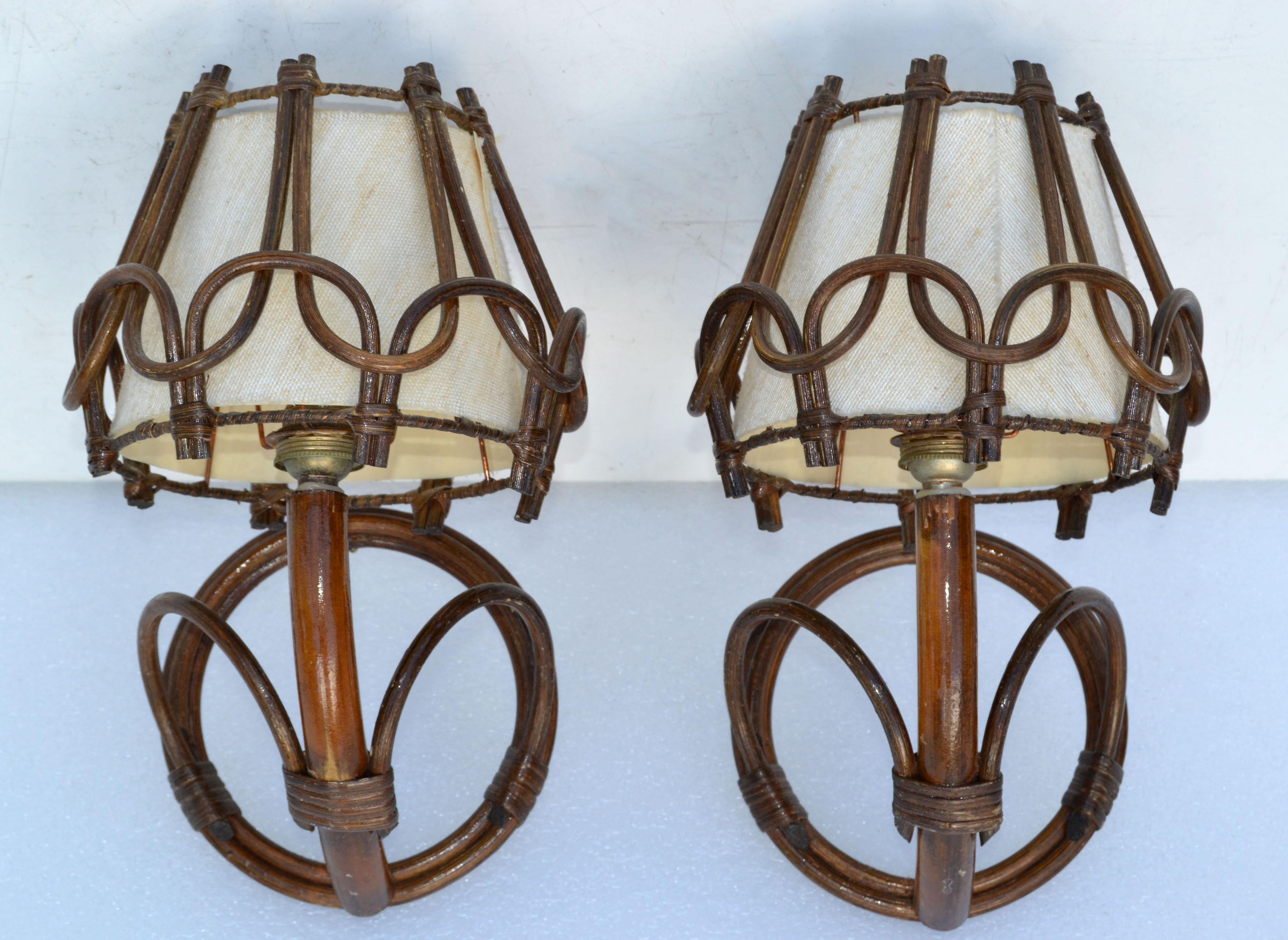 Pair of original handmade French Folk Art wall lights, sconces in bend Bamboo and cased natural fiber shades. 
takes 1 light bulb with max 60 watts.
In working condition.
Projection from the wall: 8.5 inches.
  