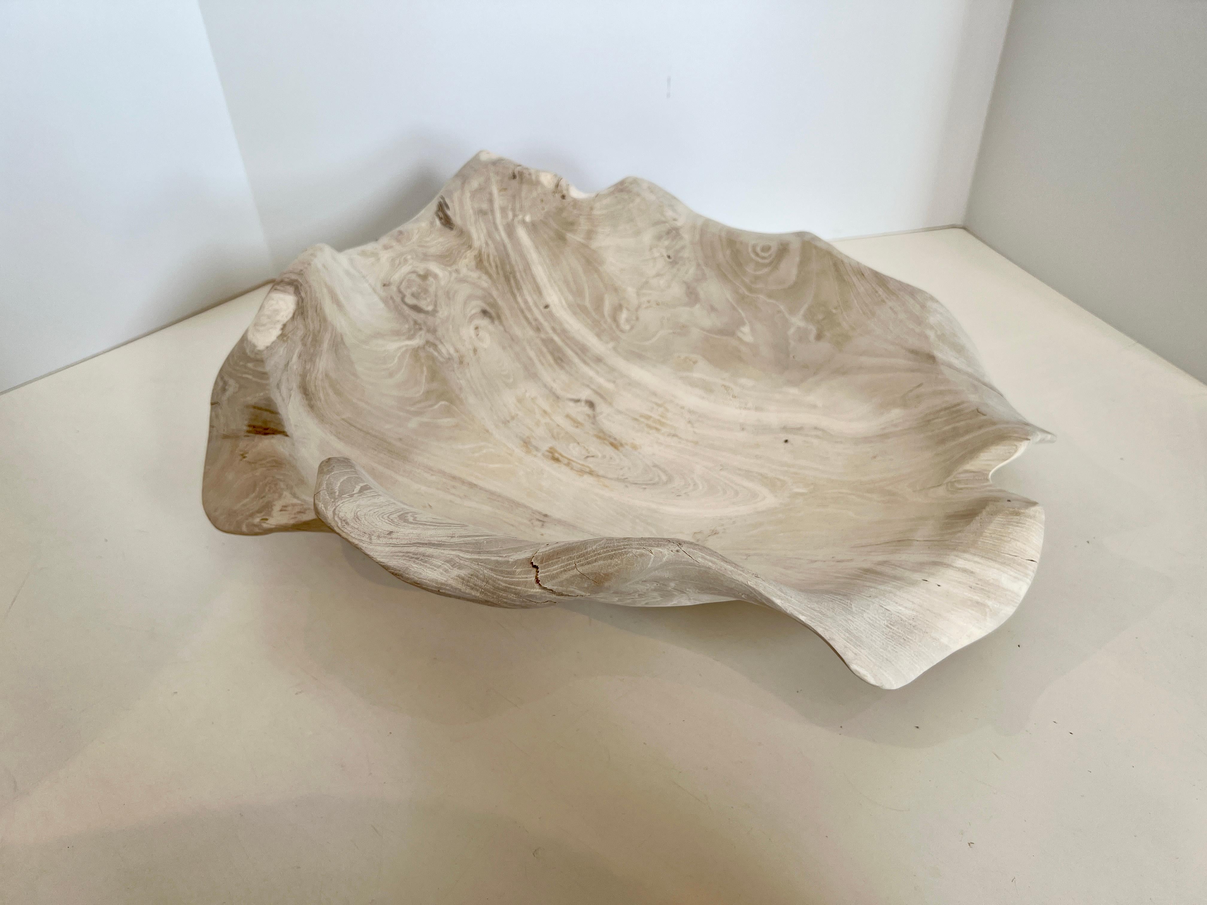 A bleached wood, hand carved bowl that almost looks like it's floating in space. Beautiful undulating curves and a generous size is perfect for displaying objects d'arts or just leaving empty.