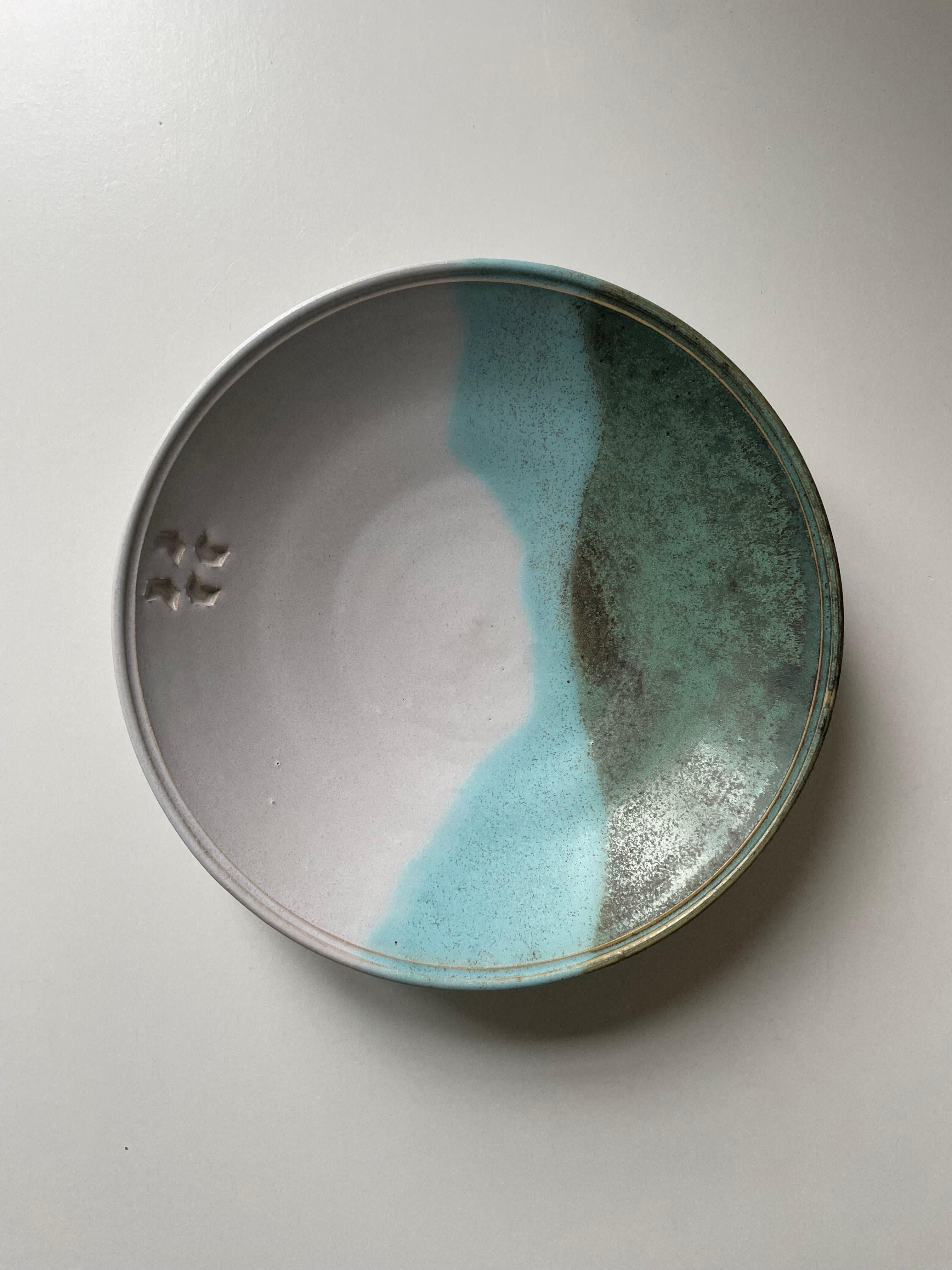 Ceramic decorative dish / bowl / wall plaque / centerpiece in white, blue and green glazed colors. Organic wavy lines and small relief mark on one side. Beautiful vintage condition. 
Denmark, 1980s.