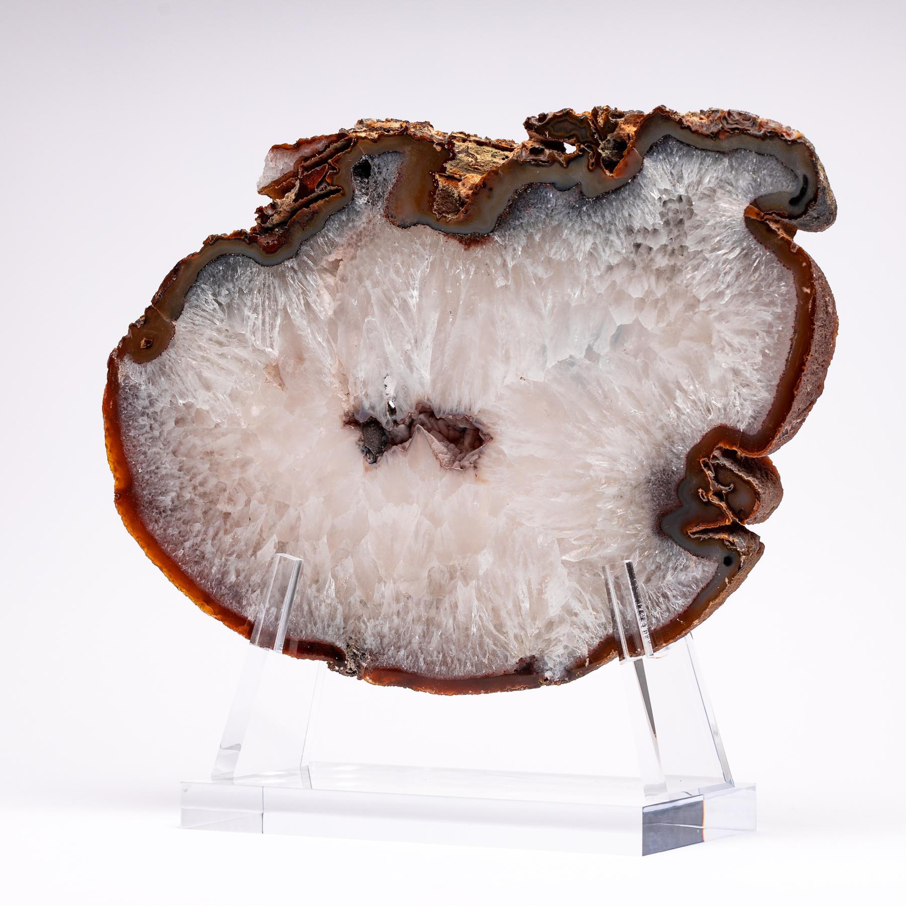 Top grade agate slab from Brazil
Agates are formed in rounded nodules, which are sliced open to bring out the internal pattern hidden in the stone. Their formation is commonly from depositions of layers of silica filling voids in volcanic vesicles