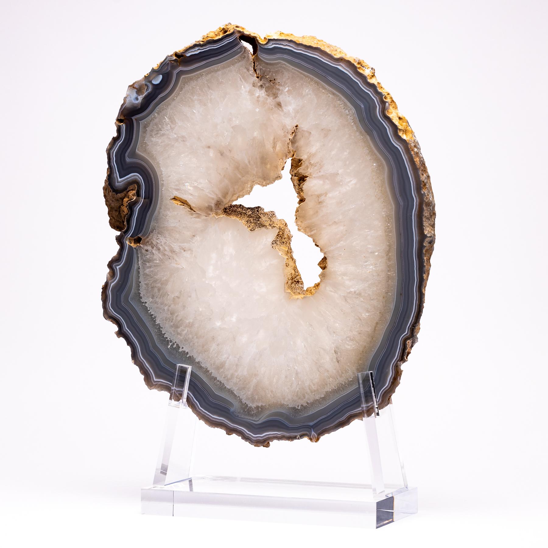 Top grade agate slab from Brazil
Agates are formed in rounded nodules, which are sliced open to bring out the internal pattern hidden in the stone. Their formation is commonly from depositions of layers of silica filling voids in volcanic vesicles