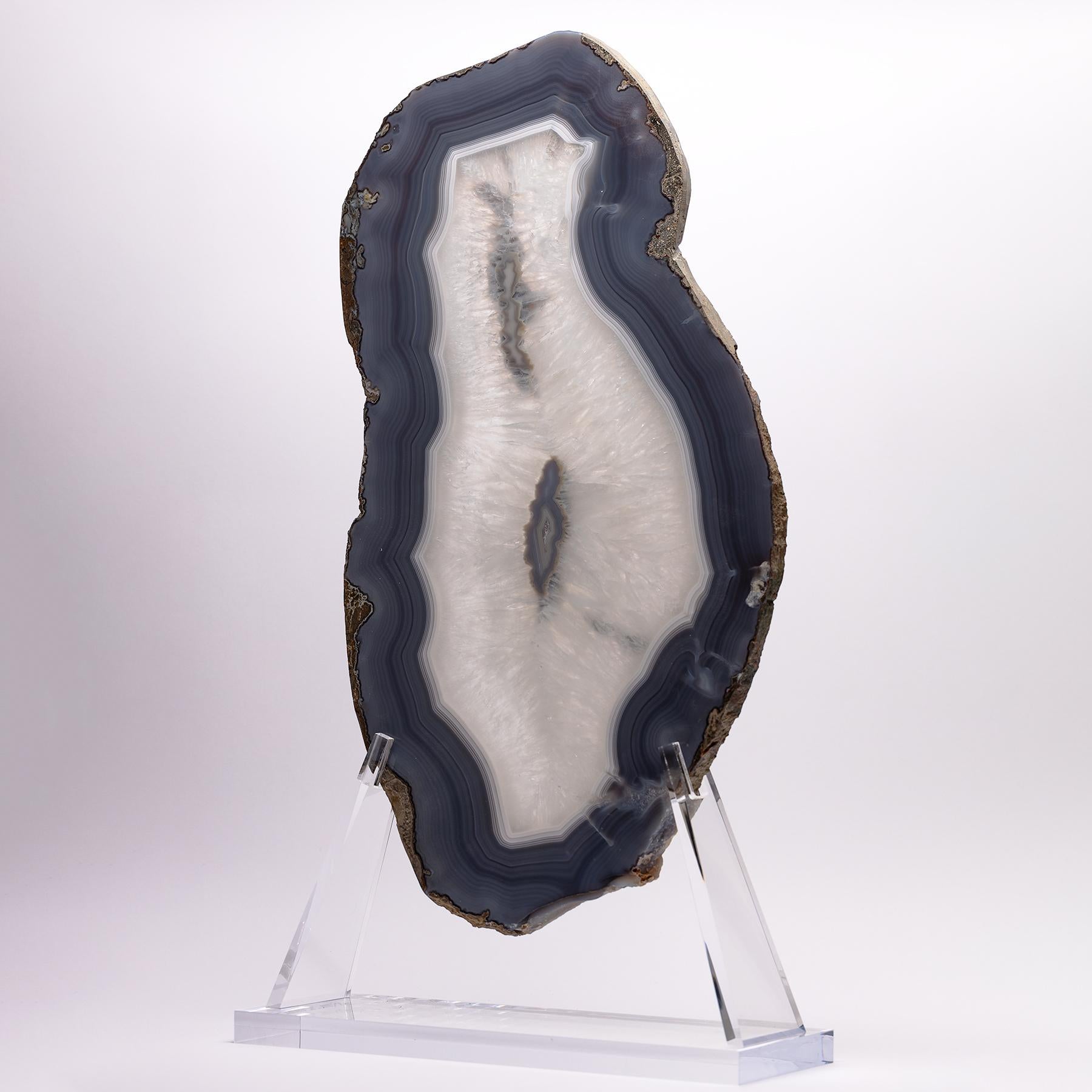 Top grade agate slab from Brazil
Agates are formed in rounded nodules, which are sliced open to bring out the internal pattern hidden in the stone. Their formation is commonly from depositions of layers of silica filling voids in volcanic vesicles