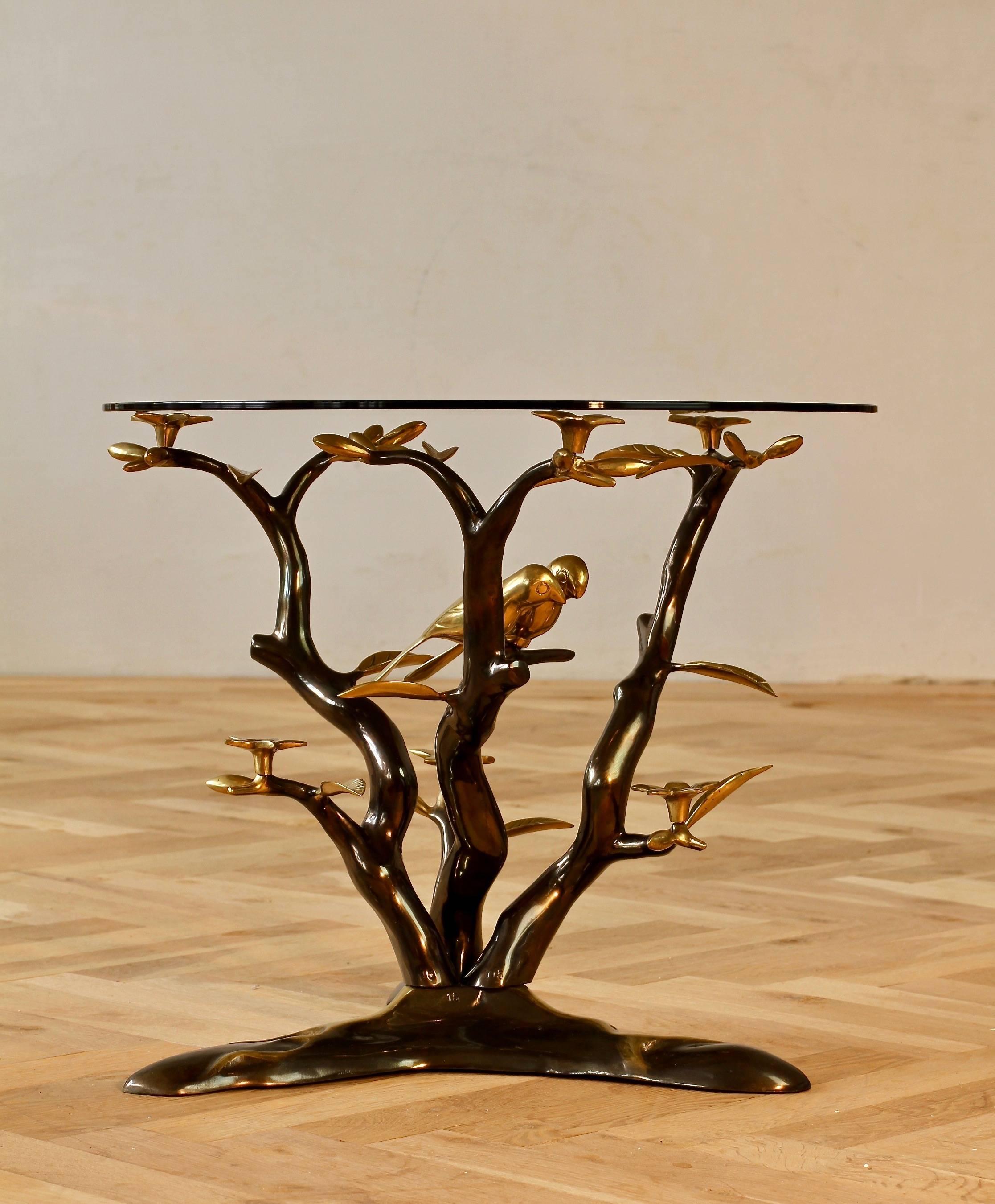A beautifully designed and crafted side or end table after Willy Daro, circa 1975. Cast in brass - the 'lovebirds' nestle amongst the branches of the 'Bonsai' tree, which support the round smoked glass tabletop, have delightful bronze finish, adding