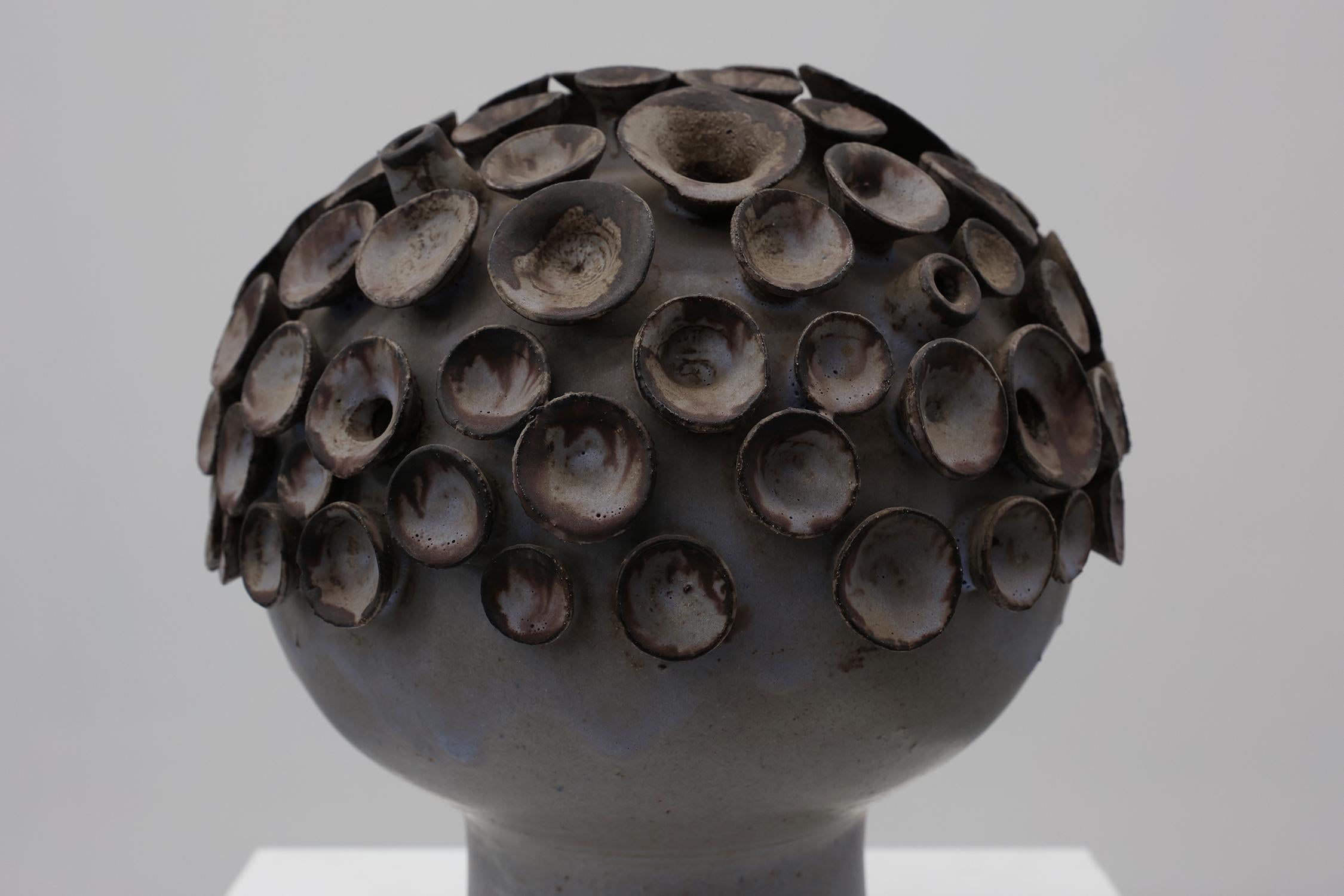 Belgium / 1960 / Art object / ceramics / Mid-century / Vintage

Spectacular original ceramic mushroom object from the 1960s, signed EL on the bottom. This sculpture in grey blue ceramics features a circular base with a ball on top full of small