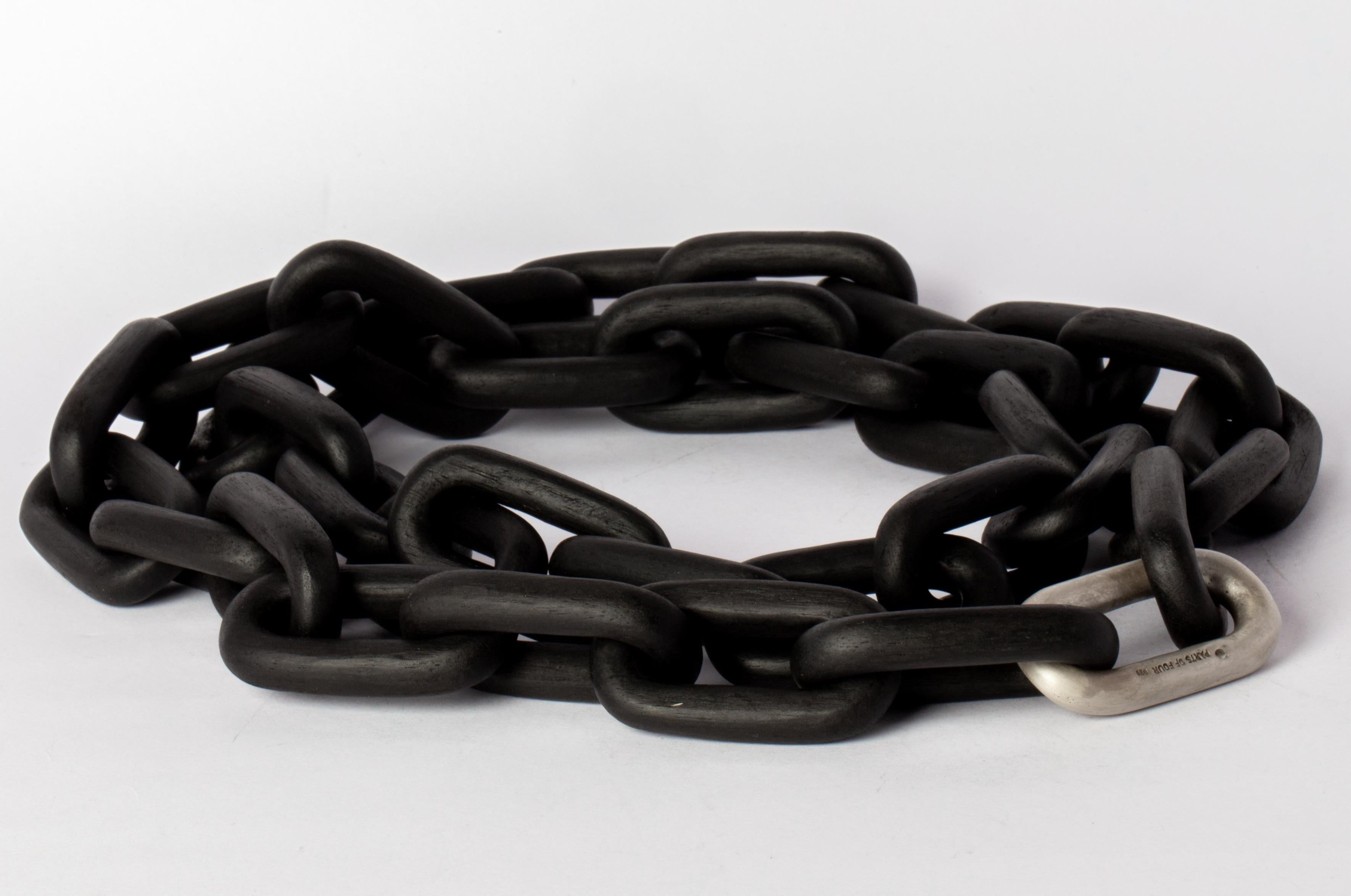 All organic chain is carved by hand. In the case of the chains made of wood, they are absolutely seamless; carved from a single long slab of wood (see link). Sterling silver, dipped in acid to create a subdued surface.
The Charm System is an