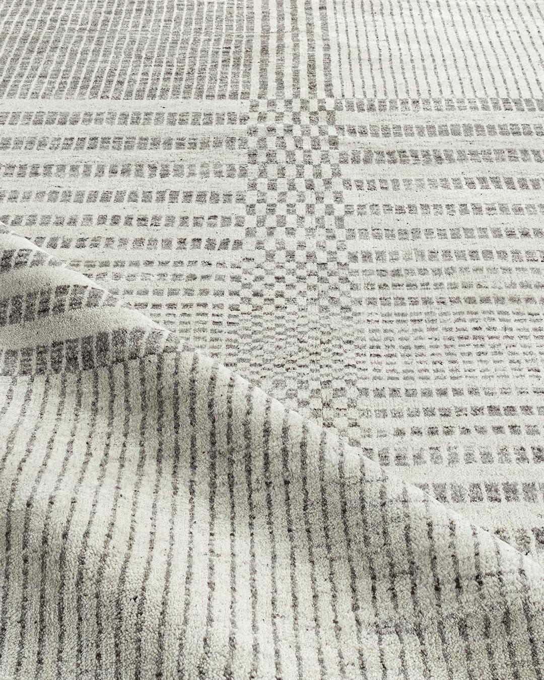 Organic checker contemporary grey area rug 10' x 14'. We call this our Organic Line because from sheep to rug, all the processes are organic and natural. The sheep are hand sheared and the wool is separated initially by color into beiges, creams,