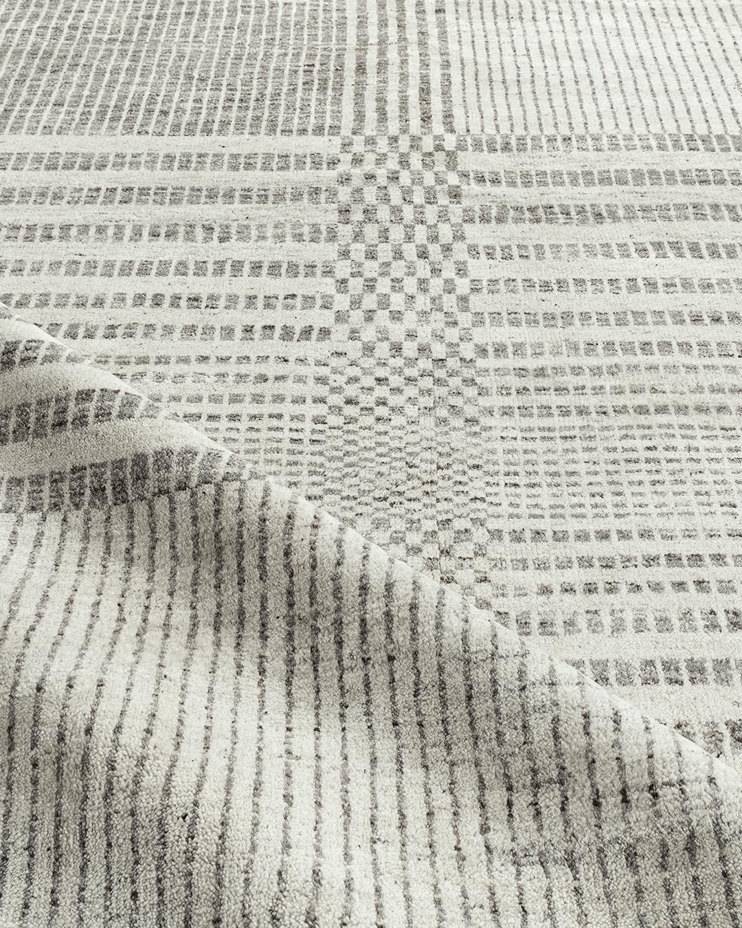 Organic checker contemporary gray area rug 9' x 11'10. We call this our Organic Line because from sheep to rug, all the processes are organic and natural. The sheep are hand sheared and the wool is separated initially by color into beiges, creams,