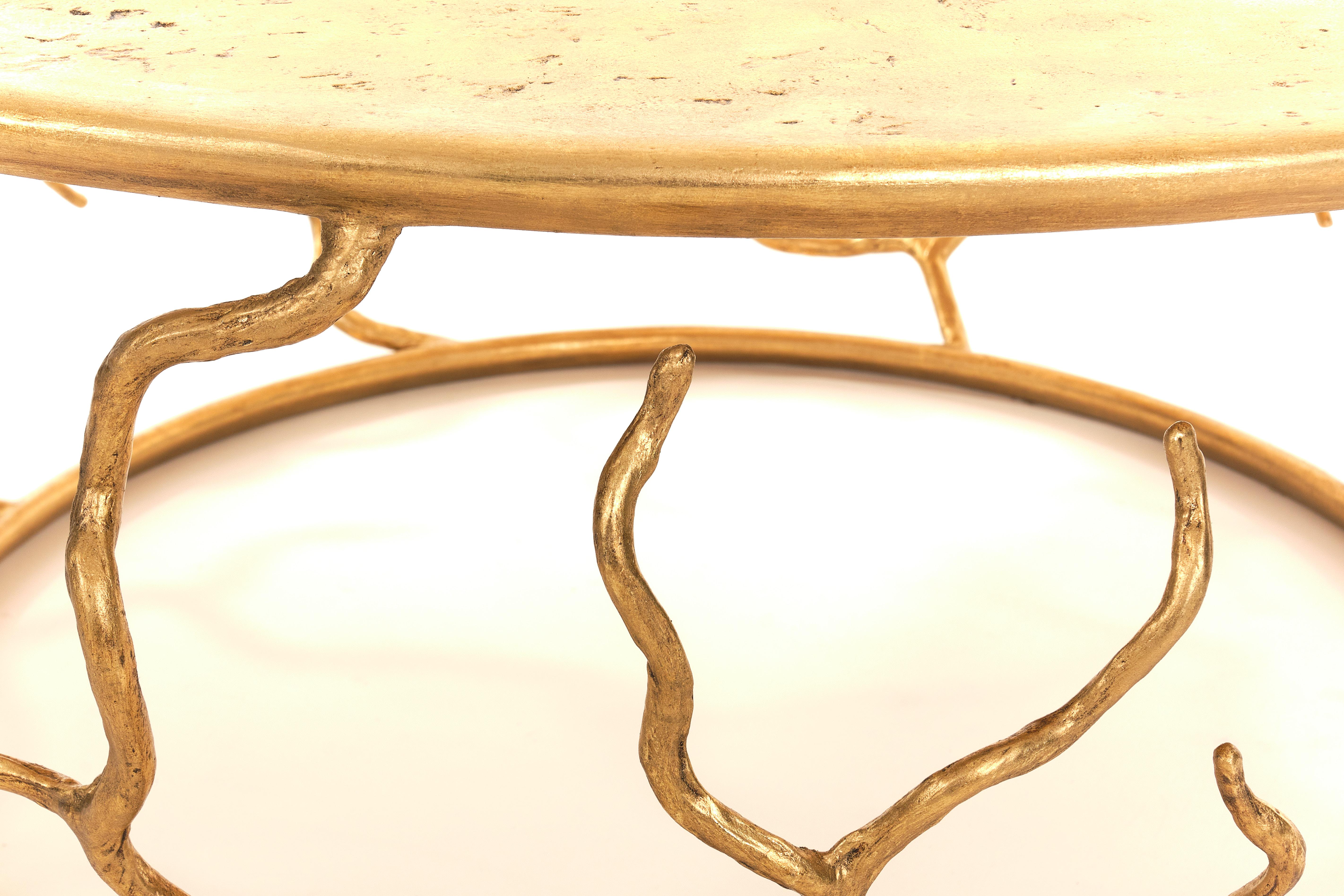 Organic forms and natural motifs. The Etna coffee table is individually hammered and hand formed. Each piece has been skillfully finished to resemble the texture of tree bark. The Top is hand-sculpted. Available also in Forest Brown Finish.