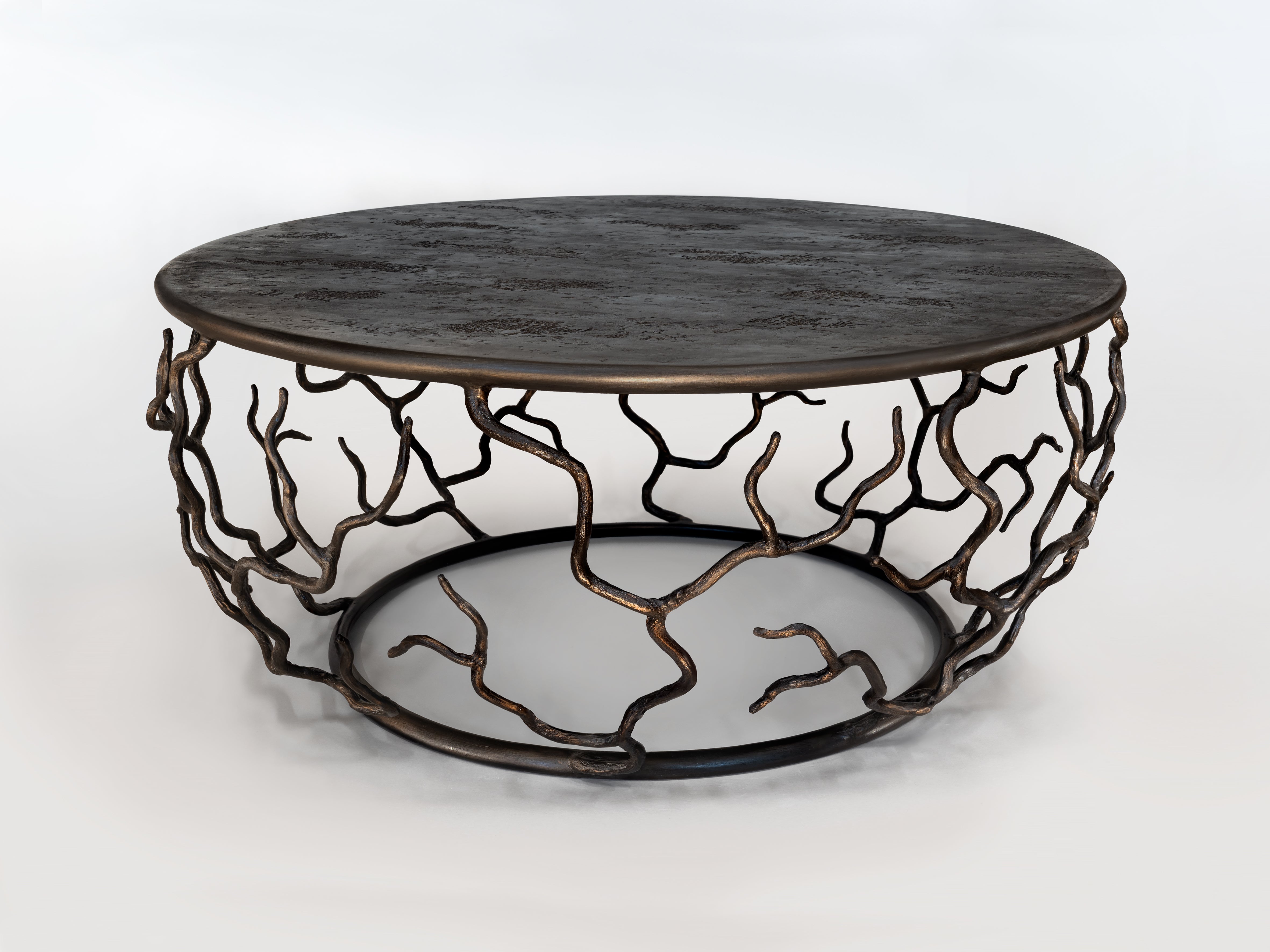 Organic forms and natural motifs. The Etna coffee table is individually hammered and hand formed. Each piece has been skillfully finished to resemble the texture of tree bark. The Top is hand-sculpted. Available also in Antique Gold Finish.
One