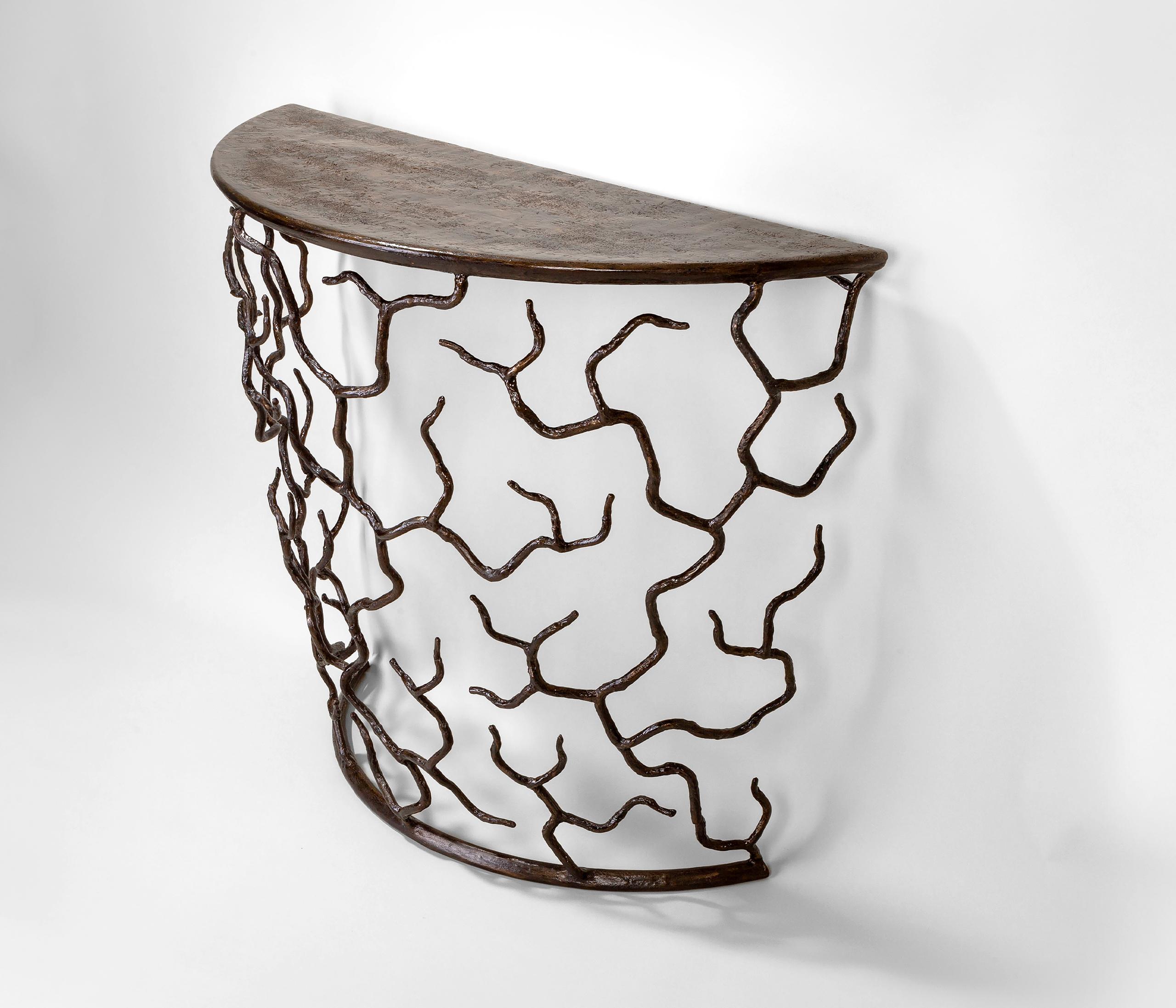Organic forms and natural motifs. The Etna console table is individually hammered and hand formed, then beautifully sculpted by layers and layers of plaster. Each piece has been skillfully finished to resemble the texture of tree bark. The Top is