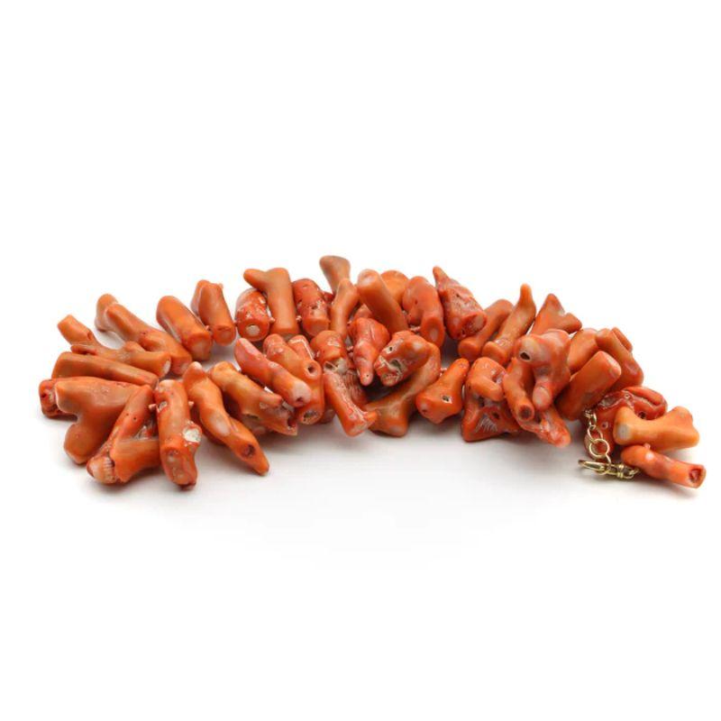 Large organic pieces of salmon-colored bamboo coral are the focal point of this bold necklace. Purchased from an estate as a parcel of bamboo coral, Kirsten’s Corner had the pieces knotted with silk thread and added a substantial 14k gold lobster