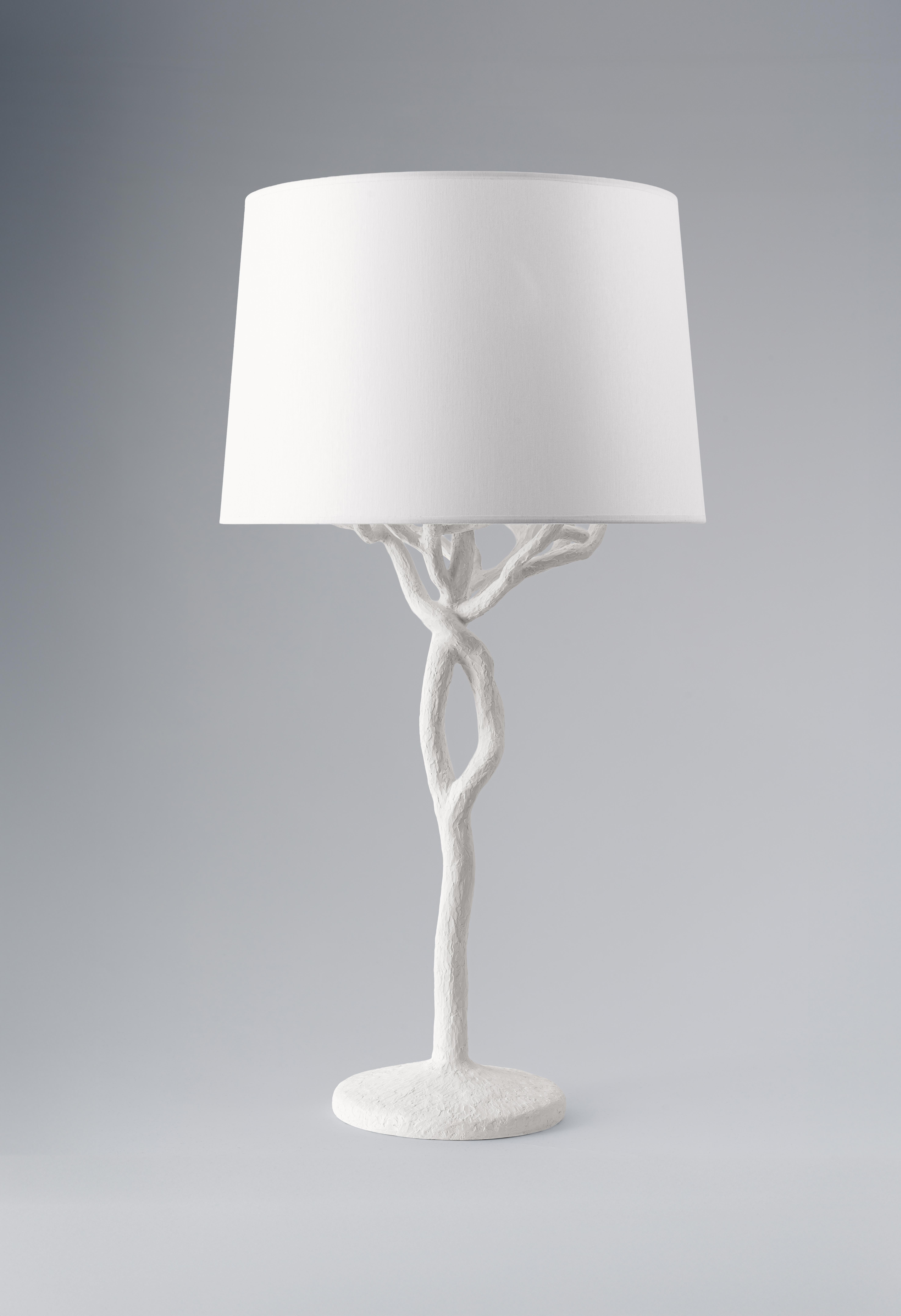 The Etna tree branch table  lamp is individually hammered and hand formed. Each piece has been skillfully finished in plaster to resemble the texture of tree bark. Available in Bronze Plaster Finish and White Plaster. This lamp is not just a source