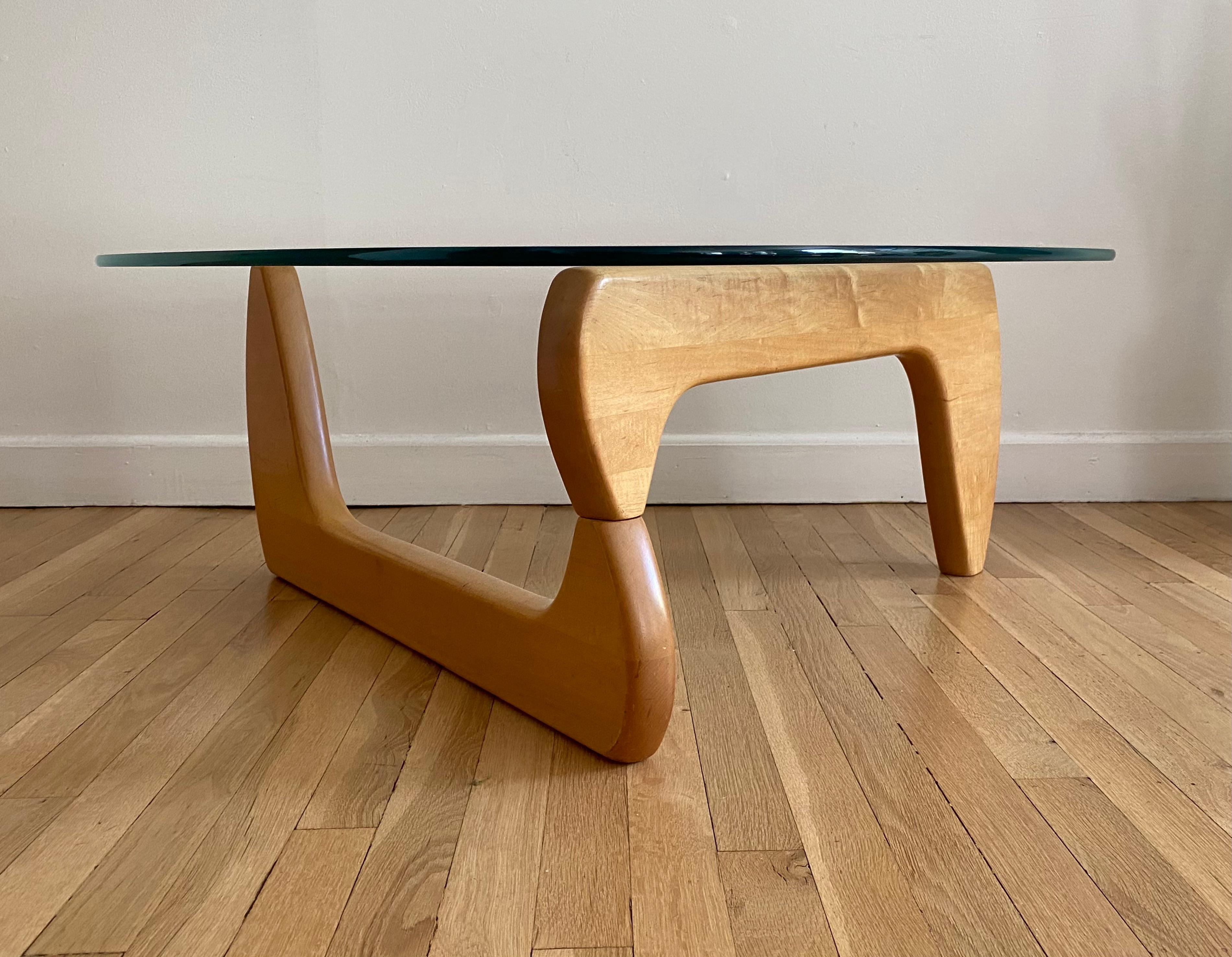 Elegant glass and wood coffee table in the style of Isamu Noguchi. Organic forms executed in glass and light toned solid wood. Minor signs of normal use, but in good even condition. Presents well with no glass chips and elegant wood tones. Will ship