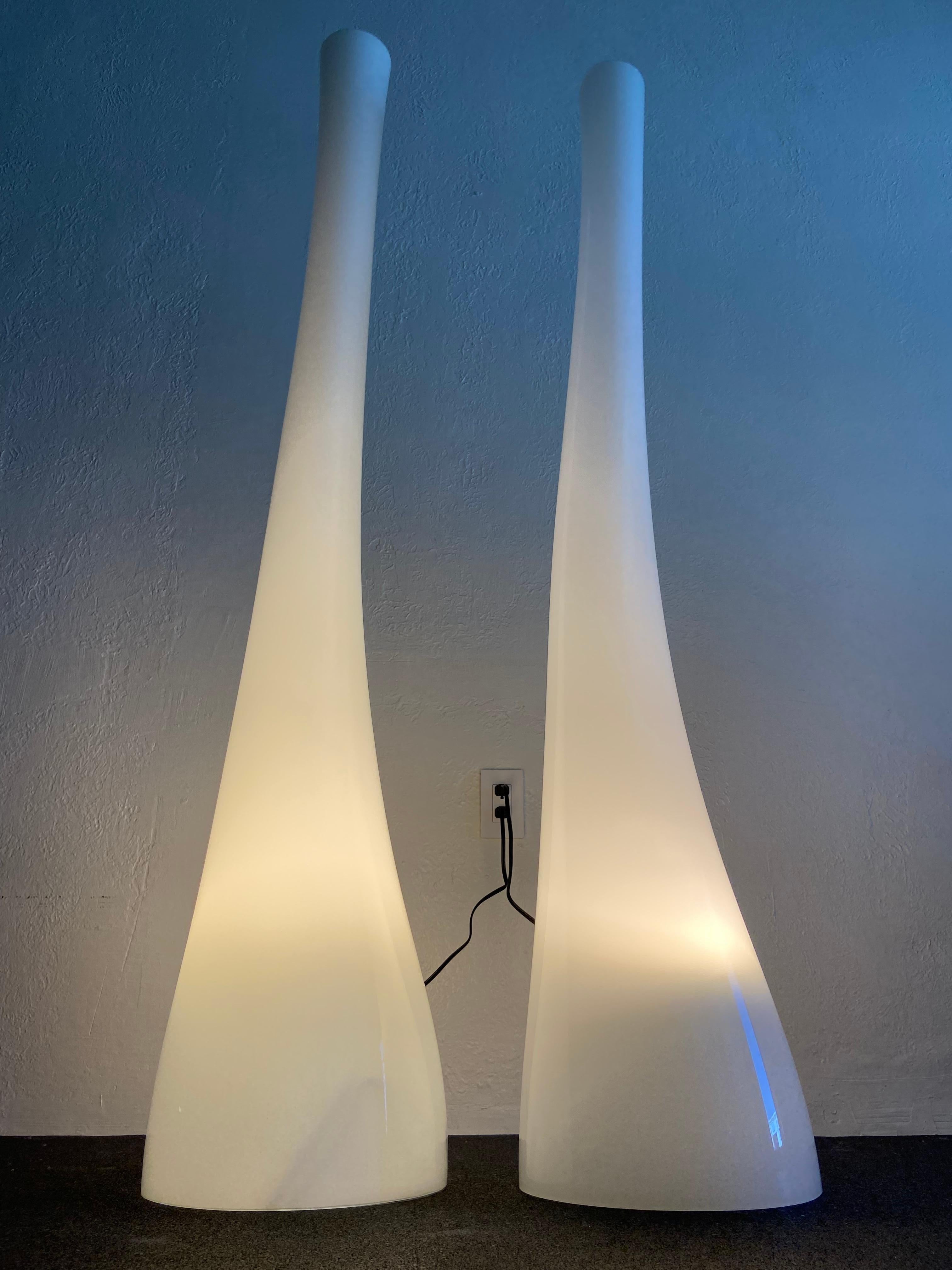 Pair of organic free-form glass floor lamps in the style of Holmegaard. Both lamps in working order with the as found original wiring. Please note that one lamp is slightly smaller. 

Larger lamp: base measures 13” across and stands 65”