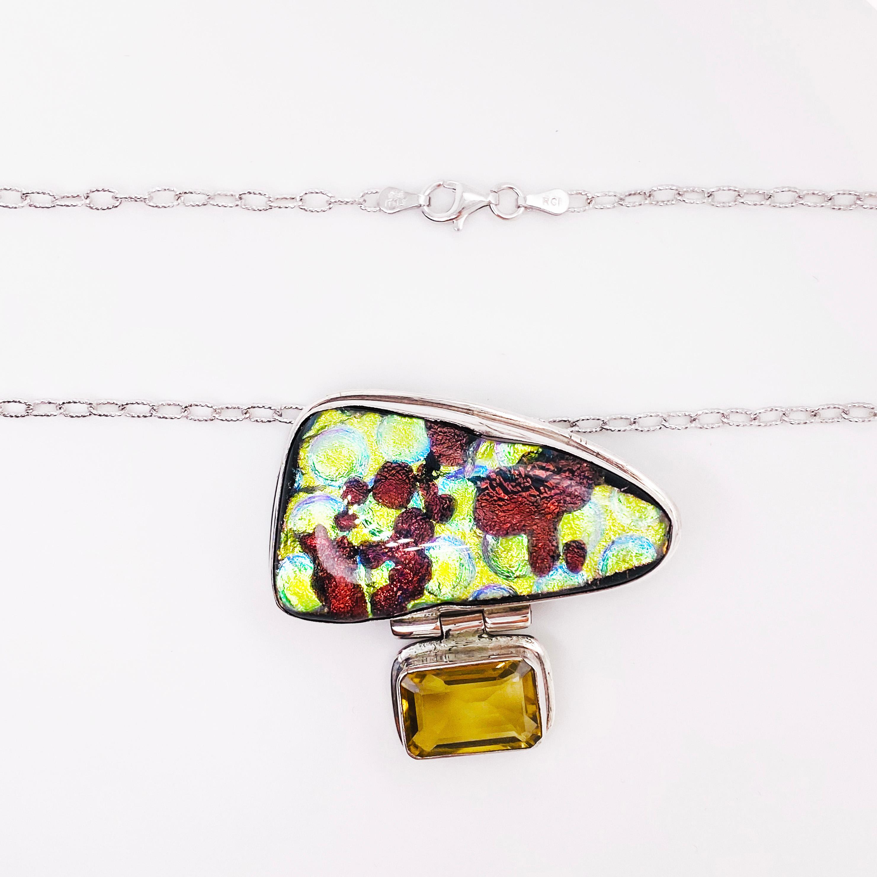 Fun, bold and quirky! This piece is so unique with an organic dichroic gemstone set in a sterling silver bezel and hanging from there an emerald cut citrine gemstone. This is quite the statement piece and sure to compliment your outfit for a special