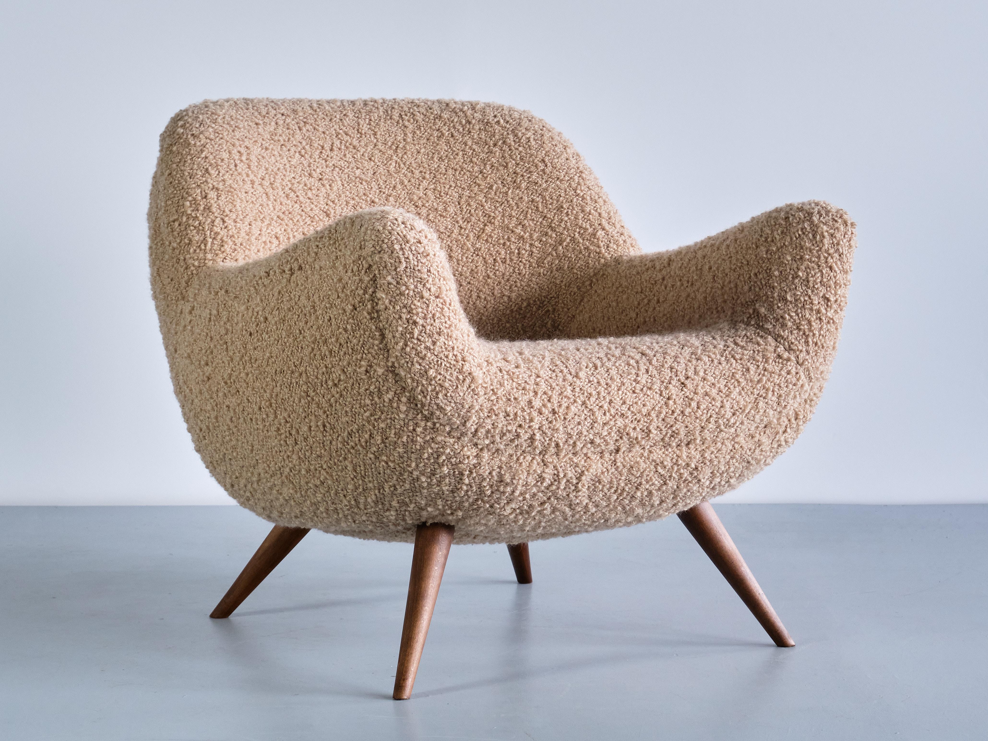 This extremely rare armchair was designed by Gustav Bergmann and produced by his company in Lippe, Germany in the early 1960s. The organic and round lines of the design give the chair a striking and inviting appearance. The seat and armrests are