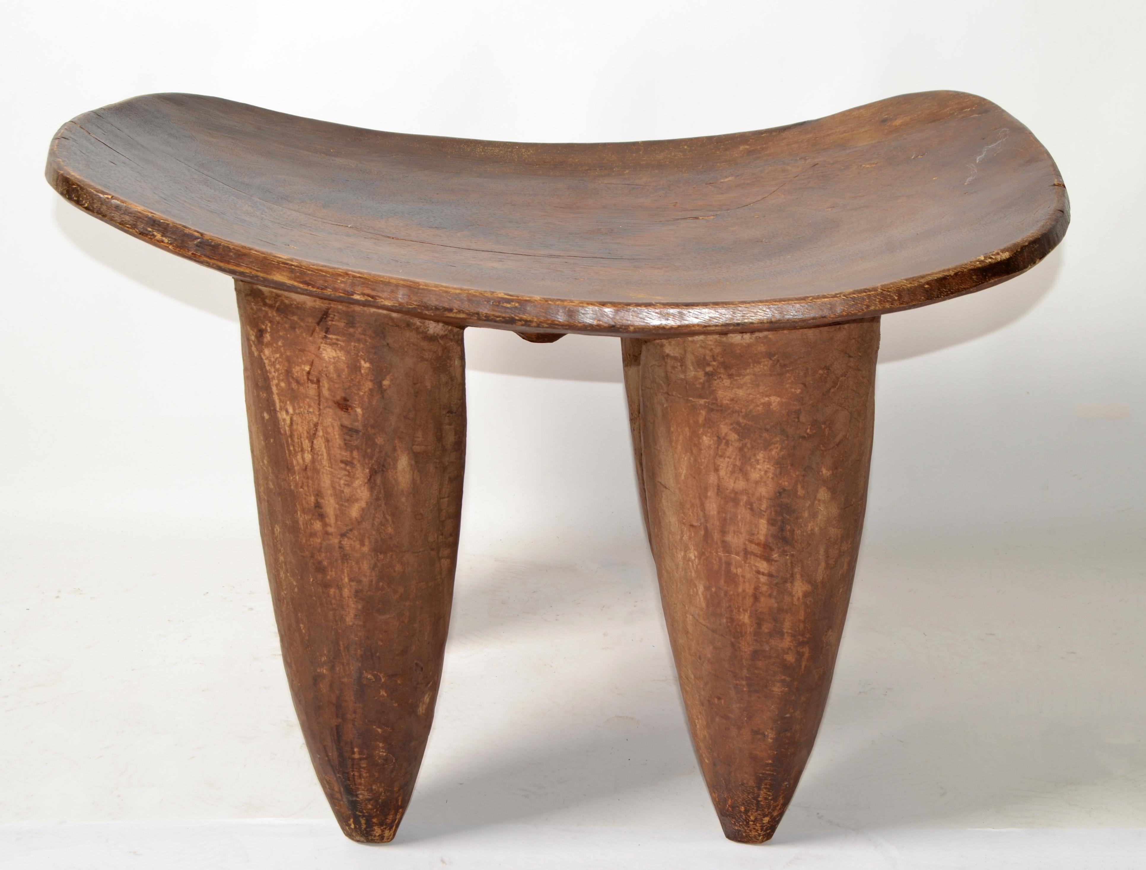 Vintage Andrianna Shamaris Senufo Style African tribal art very unique wood stool, bench, side table or headrest from a single block of wood with stunning wood grain and patina.
Sturdy and firm with cone style legs. 
The stool is left in its raw