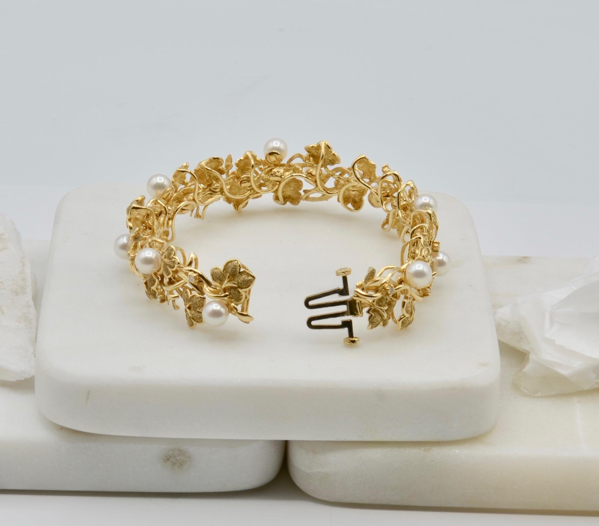 This beautiful organic inspired bracelet is intricately woven with prong set white diamonds and natural pearls. The 14 karat vine motif is interwoven with the gems and is flexible and comfortable. The clasp is very secure and easy to operate. 