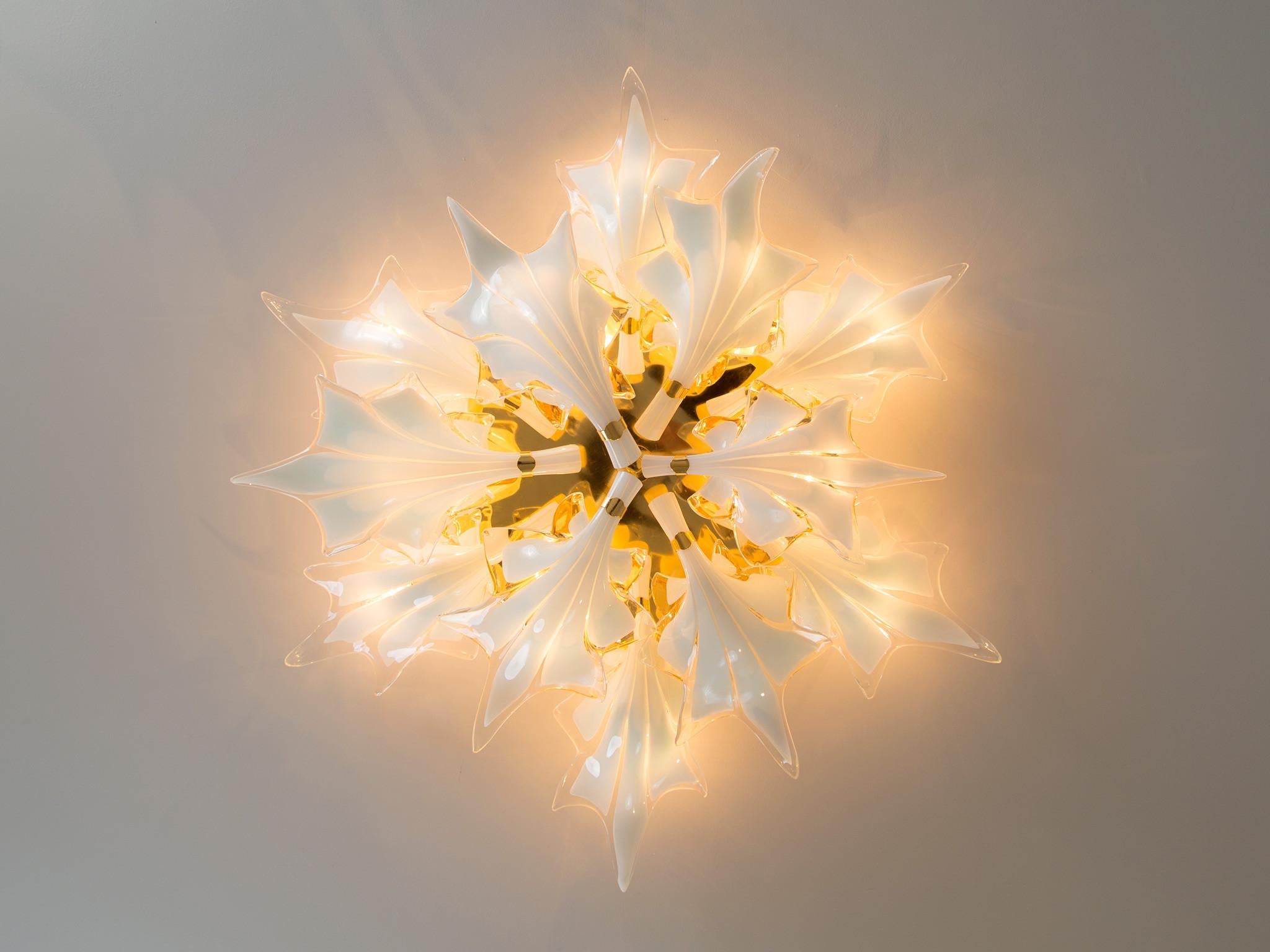 Ceiling lamp, glass, brass, mirror, Italy, 1970s

Elegant and organic shaped ceiling lamp made in Italy. The form of the lamp reminds of lilies, which give the lamp a floral feeling. The delicate shape of the 'leaves' is emphasized by the white