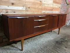 organic large teak Vintage sideboard featuring beautifully sculpted wave handles
