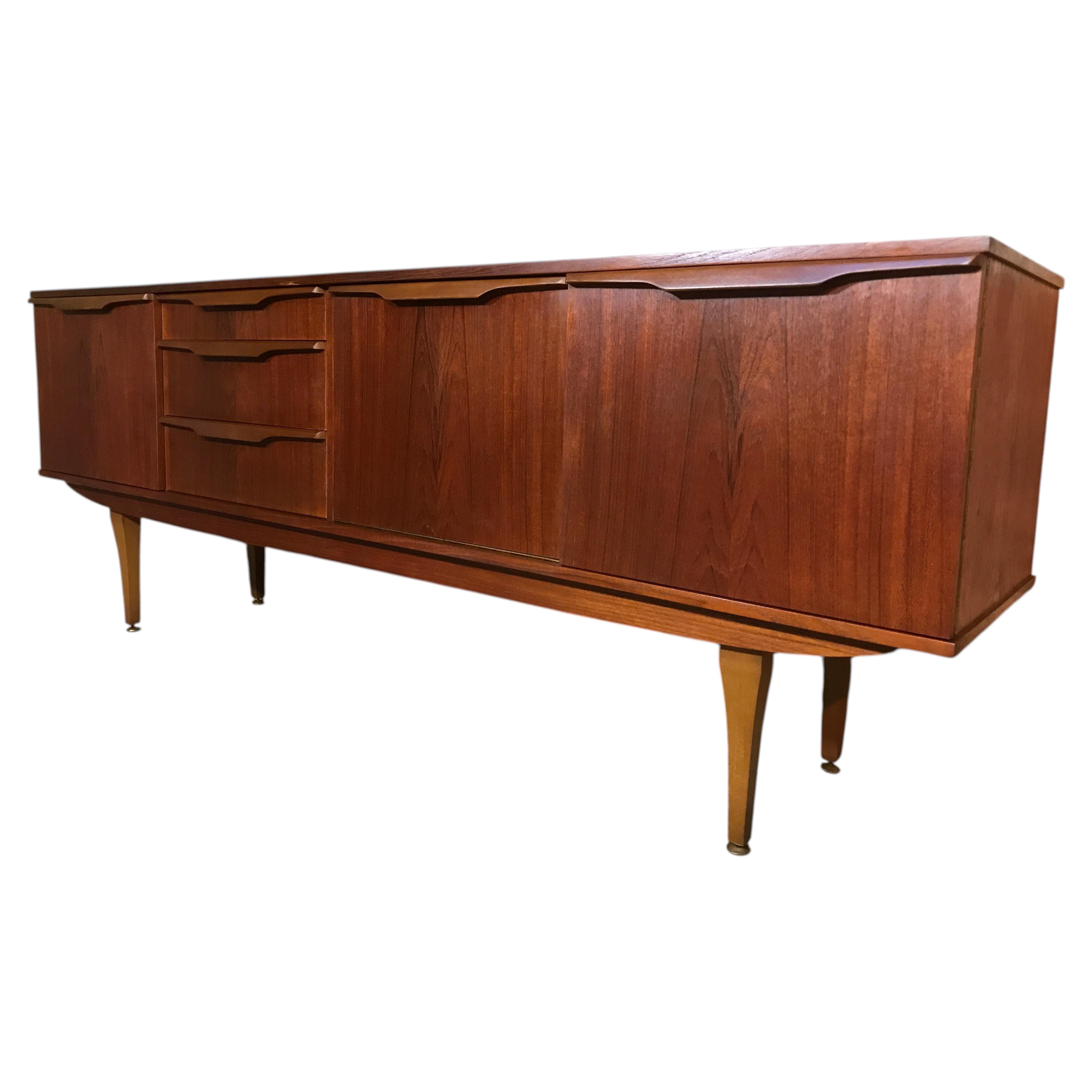 organic large teak Vintage sideboard featuring beautifully sculpted wave handles