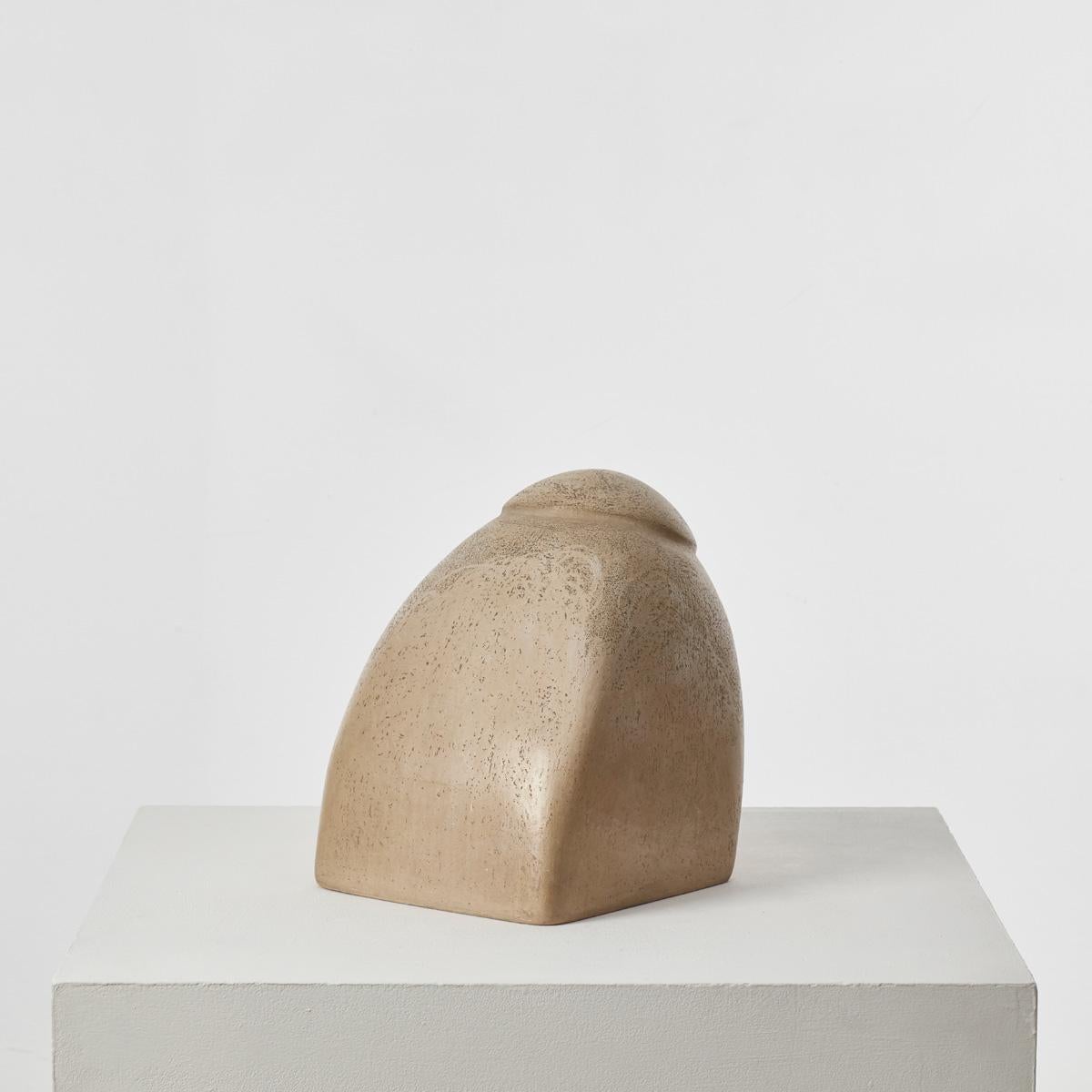 A large, biomorphic plaster sculpture with a burnished finish that sits as a solid piece with a dynamic slanted axis. It was previously owned by Sir Terence Conran (1931 - 2020). Conran, an inimitable design pioneer and businessman, “did more than