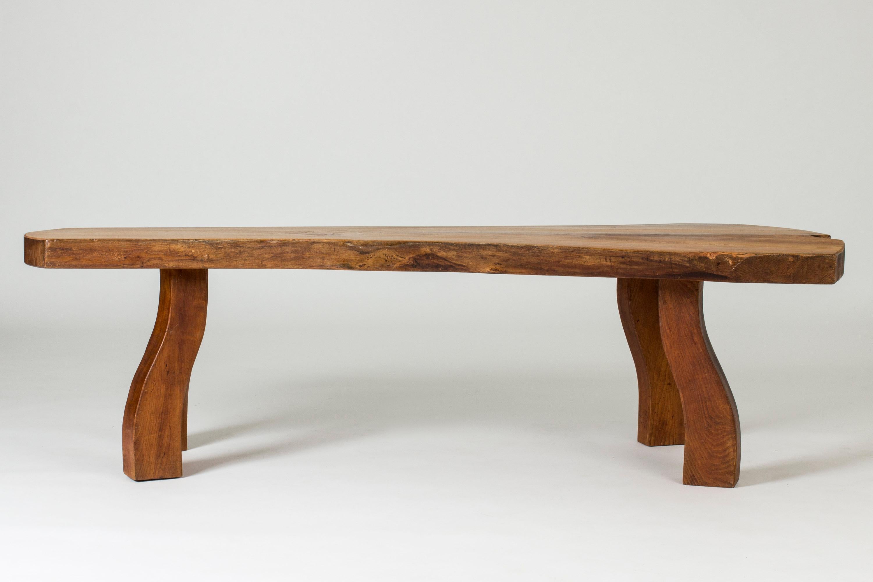 Striking elmwood coffee table by Carl-Axel Beijbom, made from an elmwood slab with lovely wood grain. Beautiful, oiled surface. Sturdy, sculpted legs that pick up the organic design of the tabletop.

The story of the striking elmwood tables from