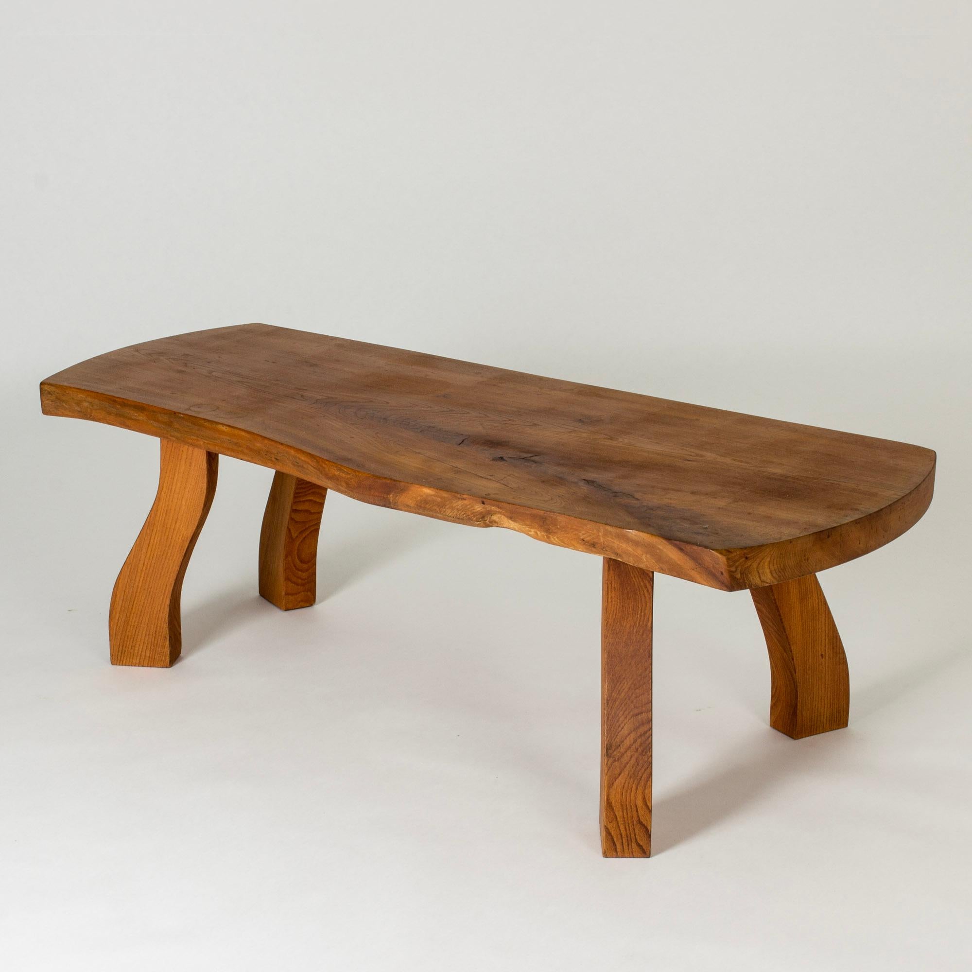 Striking elmwood coffee table by Peter Beijbom, made from an elmwood slab with lovely woodgrain. Beautiful, oiled surface. Sturdy, sculpted legs that pick up the organic design of the table top.

The story of the striking elmwood tables from C. A.