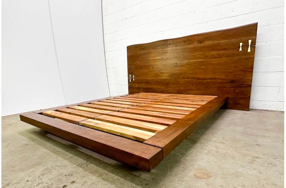 Contemporary organic free live edge wood slab headboard queen platform bed.
Organic free edge headboard platform bed handcrafted in solid wood headboard.
This solid wood headboard with decorative brass bow tie accents combines natural organic beauty