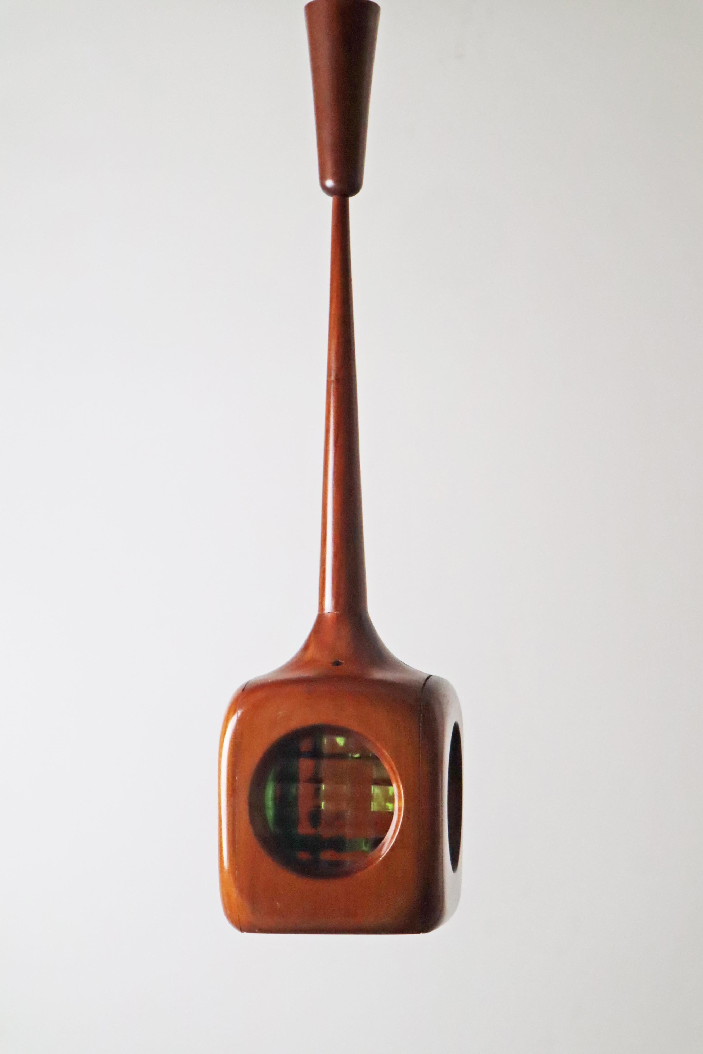 Beautiful, organically crafted mid-century modern pendant lamp. The shape is absolutely extraordinary and reminiscent of a drop, the wood was carefully crafted and forms an organic overall picture with the canopy. The different colored stained glass