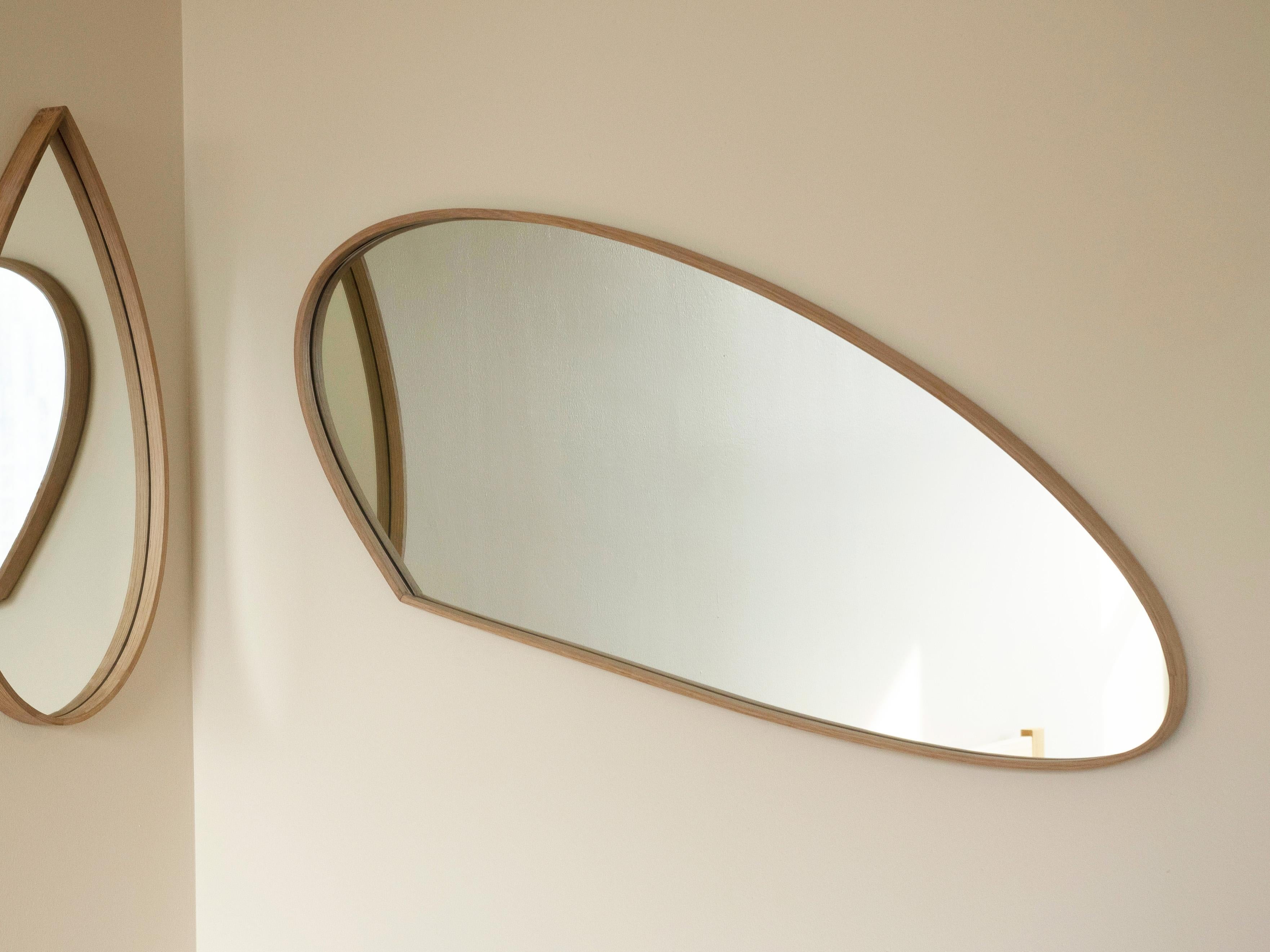 This wall mirror by Soo Joo uses wooden steam-bending techniques to create an Organic Mirror design. They have a timeless beauty that is not affected by changing trends and can be enjoyed for decades. The sculptural mirror fits into any interior