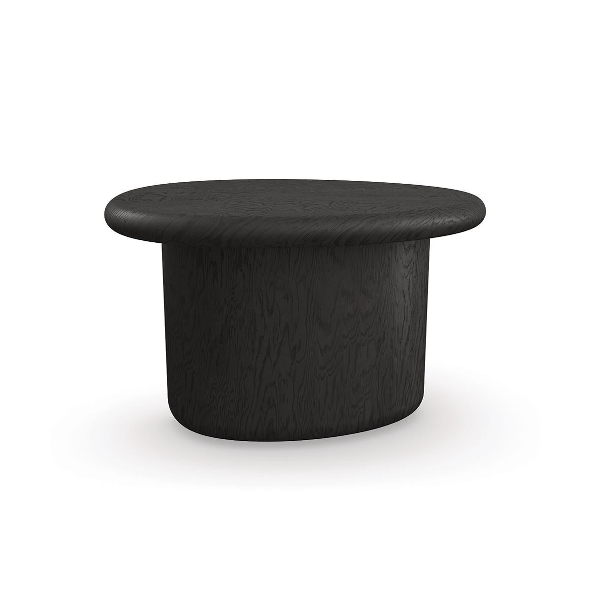 With its petite, pebble shape poised on a single curved foot, the table makes an organic yet elegant statement. Crafted in Tamo ash veneers and a dramatic dark coal finish, this versatile accent table is designed to complement our matching cocktail