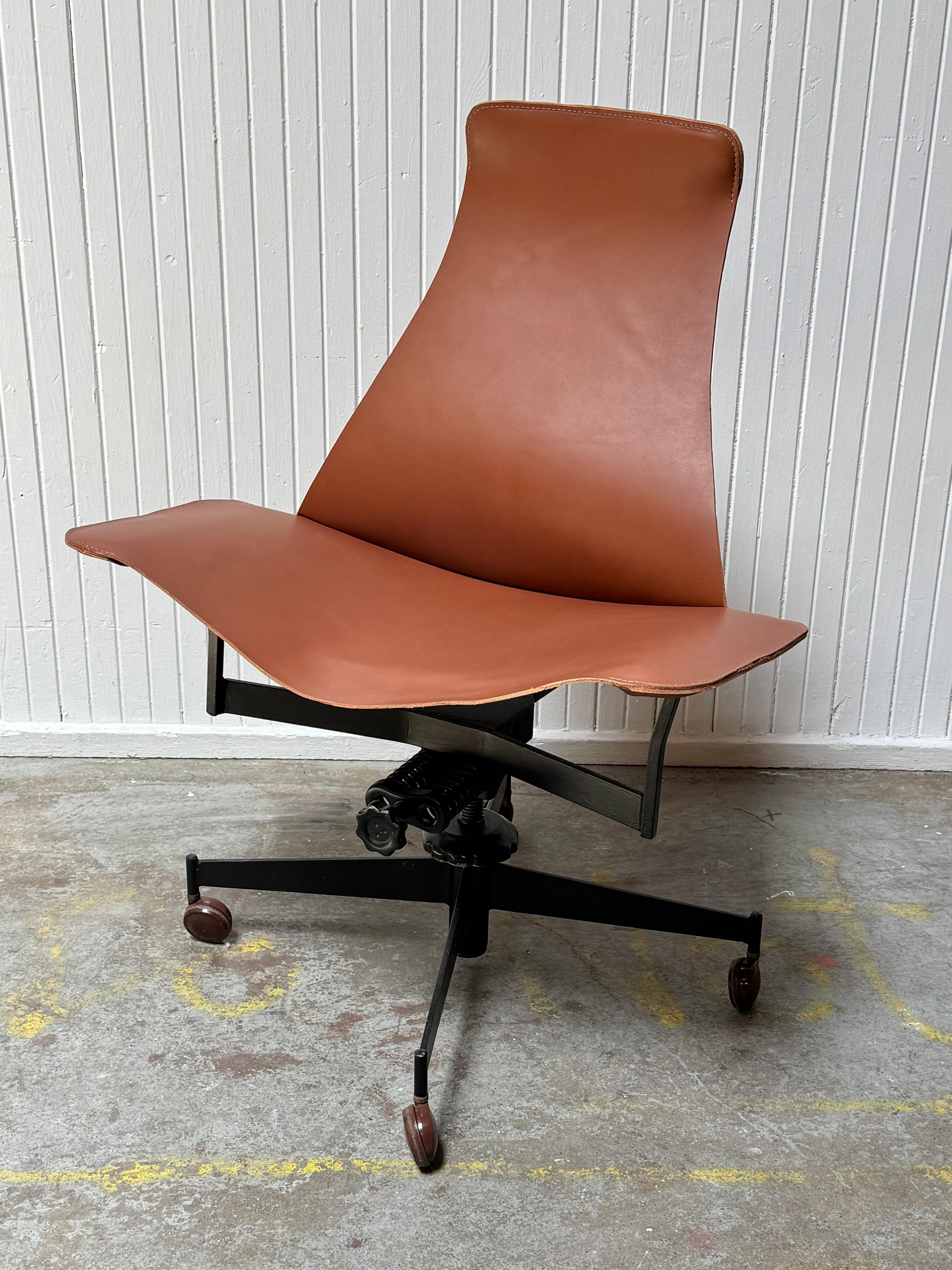 A metal framed swiveling, height-adjustable chair with reclining tension control in brown leather by American architect and designer William Katavolos for Leathercrafter. With its casters, it makes for a  perfect office chair, but can also be used