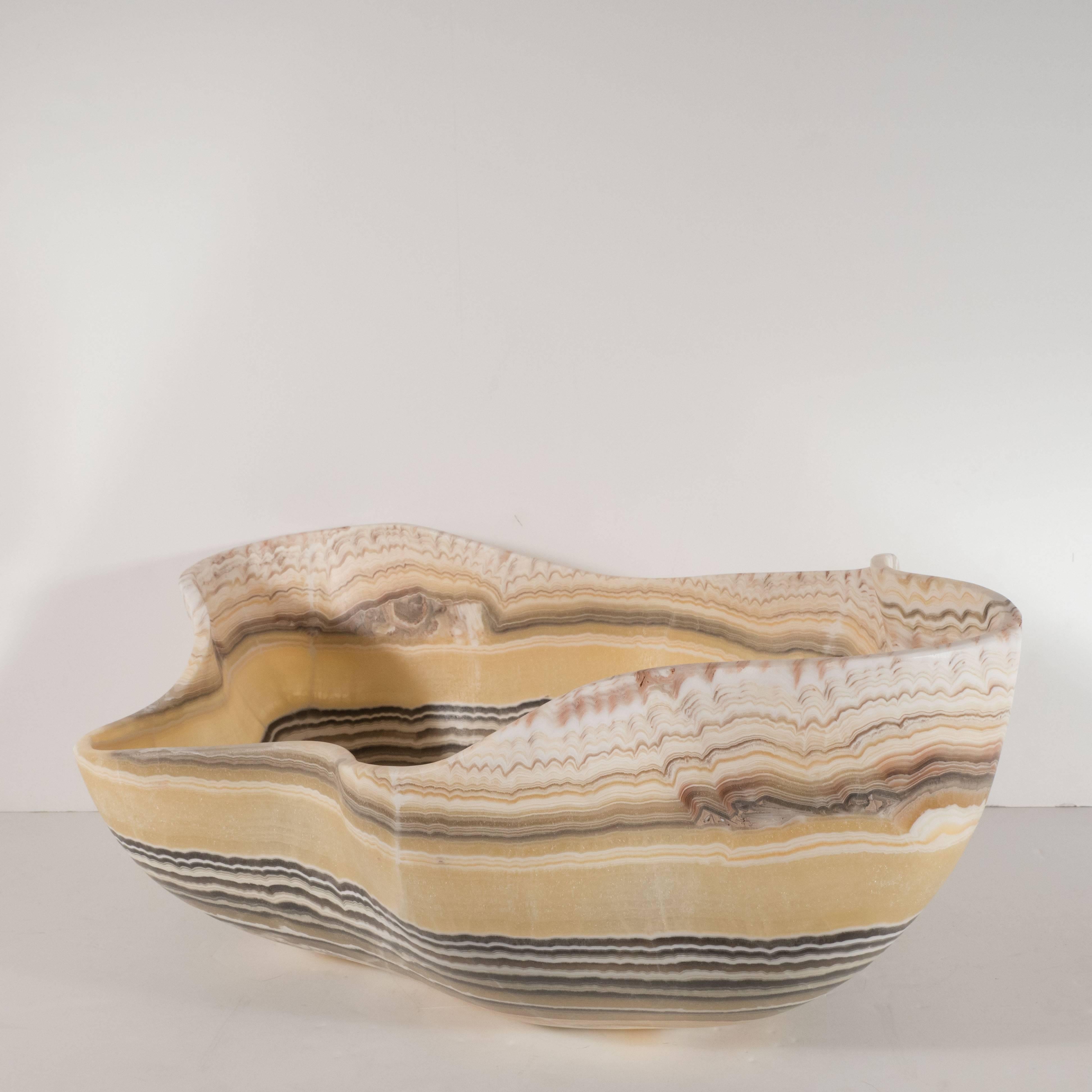 This compelling organic modern agate bowl features a wealth of texture in grisaille tones of charcoal, cream, and white set against a honey background, which adds a touch of warmth to the otherwise monochromatic palette. This piece showcases the