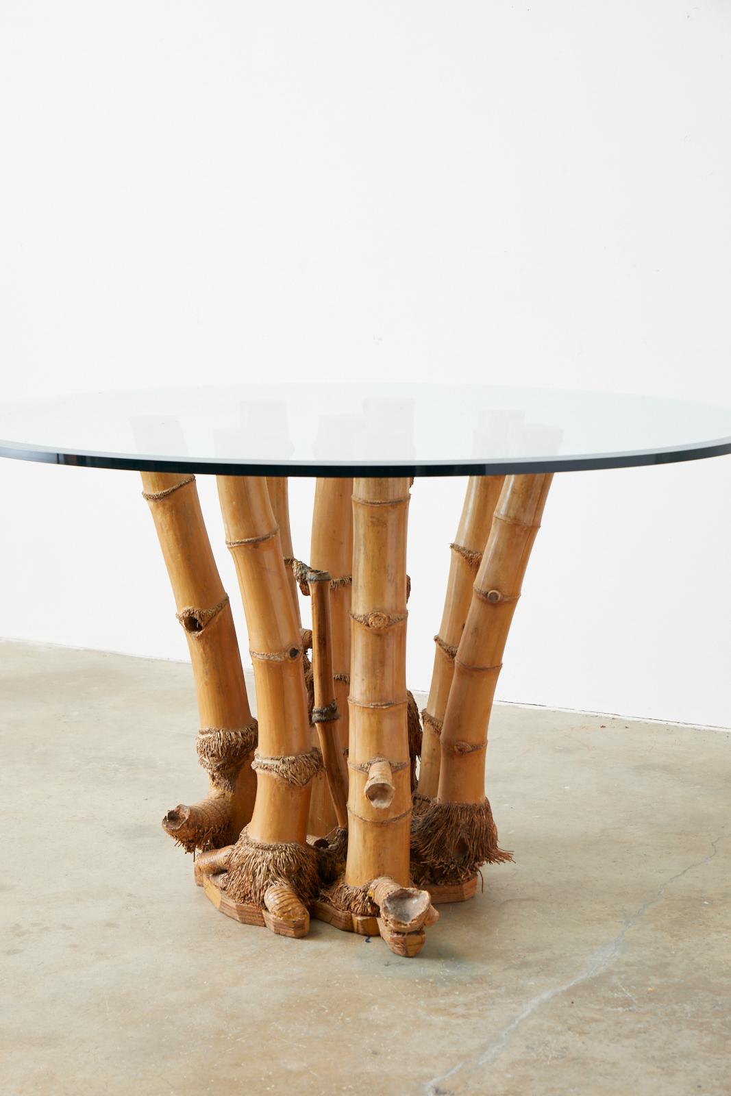 Large round glass top dining table featuring an organic modern style bamboo root base. Rare 8-leg bamboo stalks with their roots and base intact which is seldom seen usually only when the farms and trees are retired. Topped with a .75 inch thick